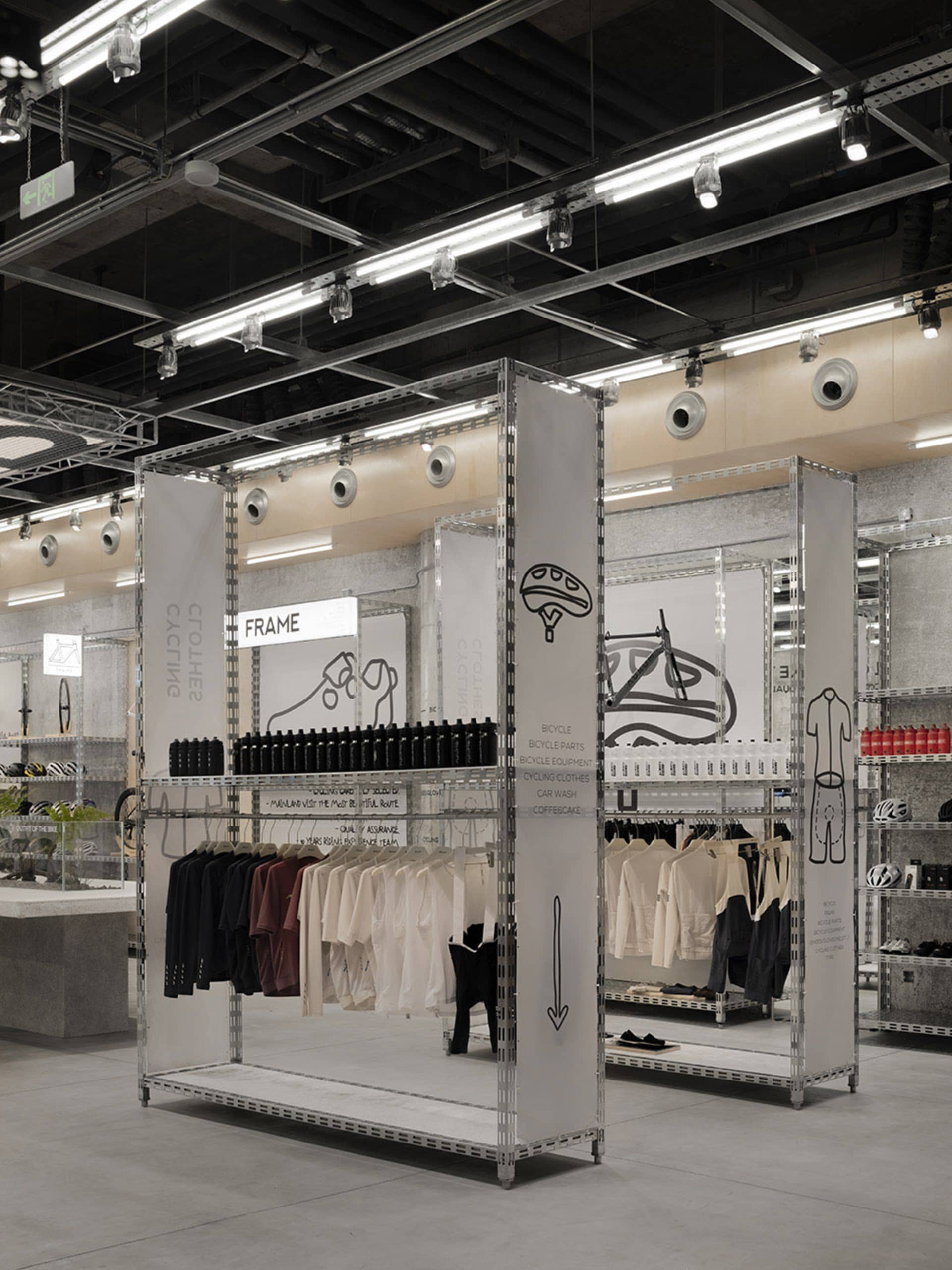 Modern retail store with metal frames displaying clothing and accessories