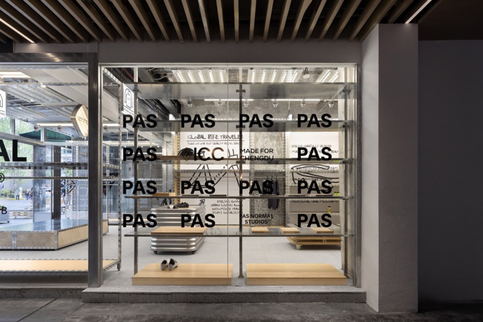 Modern retail storefront with transparent glass panels and minimalist design elements.