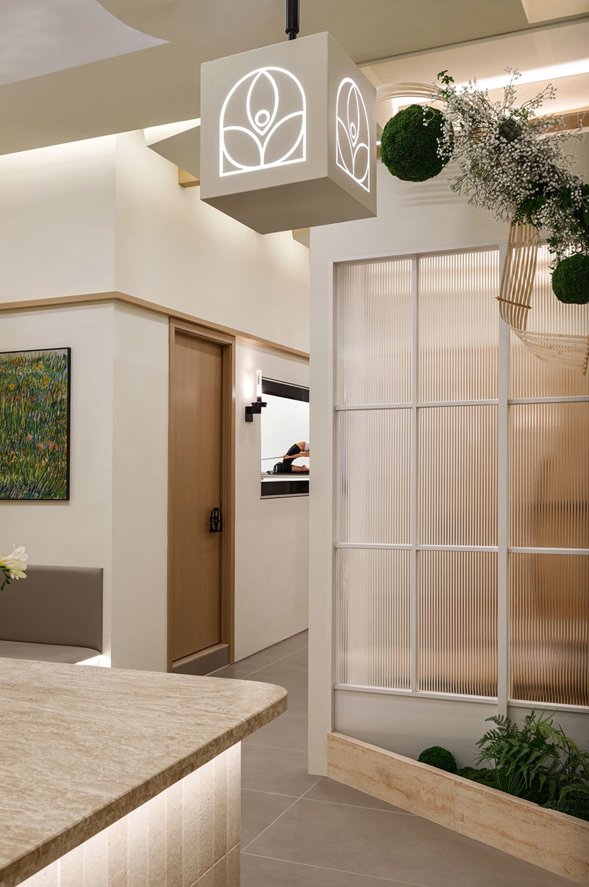 Spacious and sleek spa interior designed with modern materials such as glass and wood.