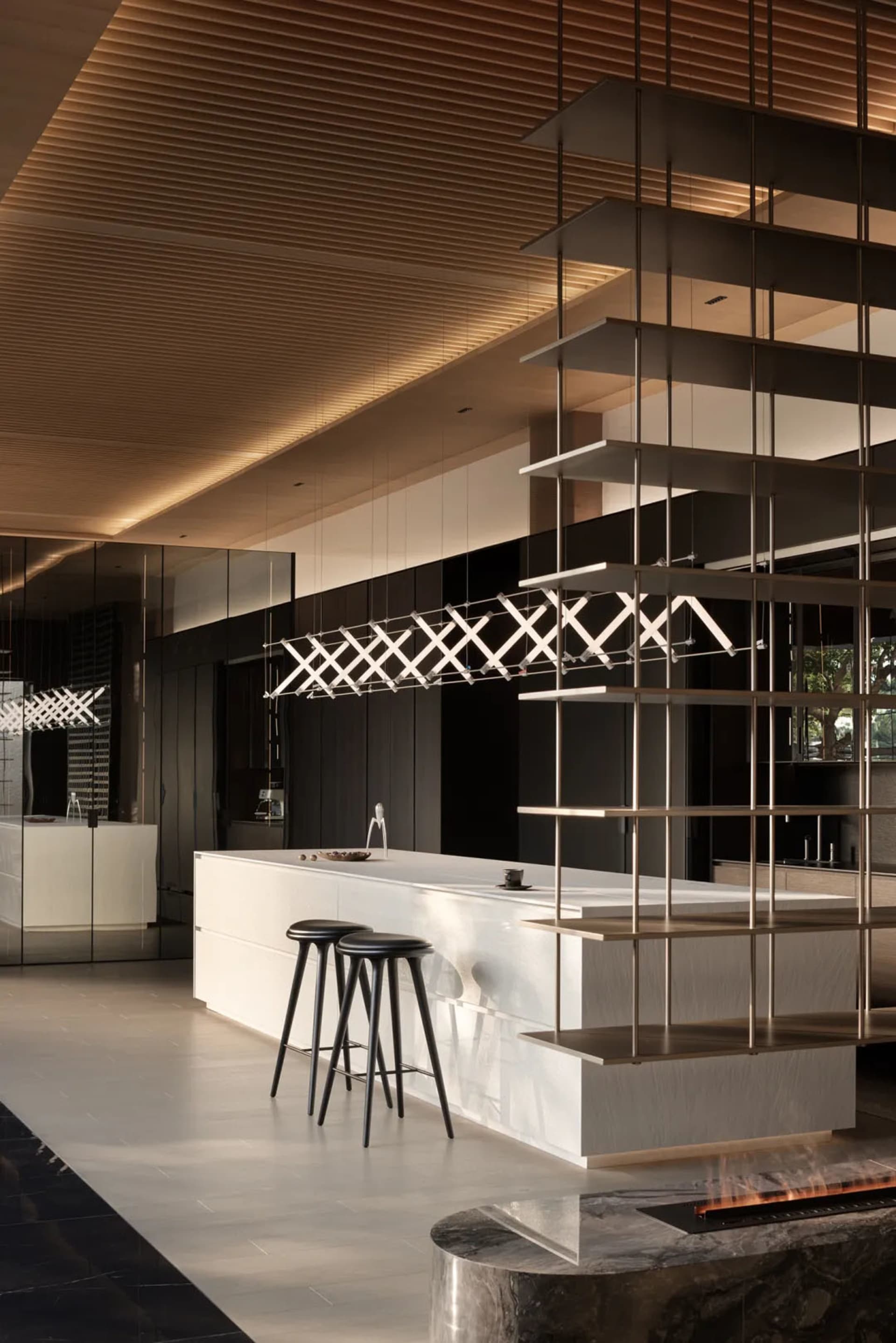 A modern residential kitchen with minimalist design features and mixed materials.