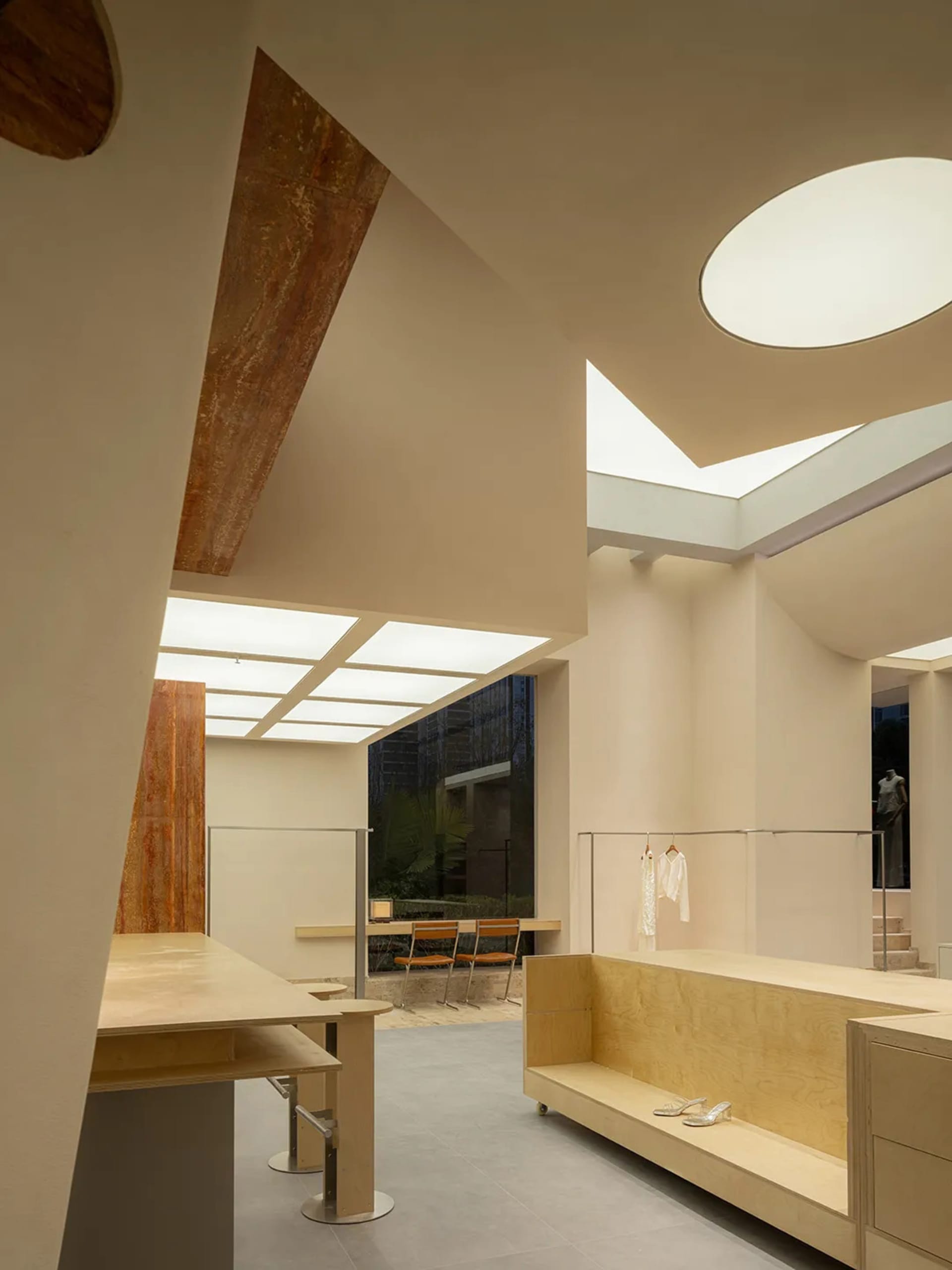 Minimalist interior space featuring a mixture of wood and glass materials.
