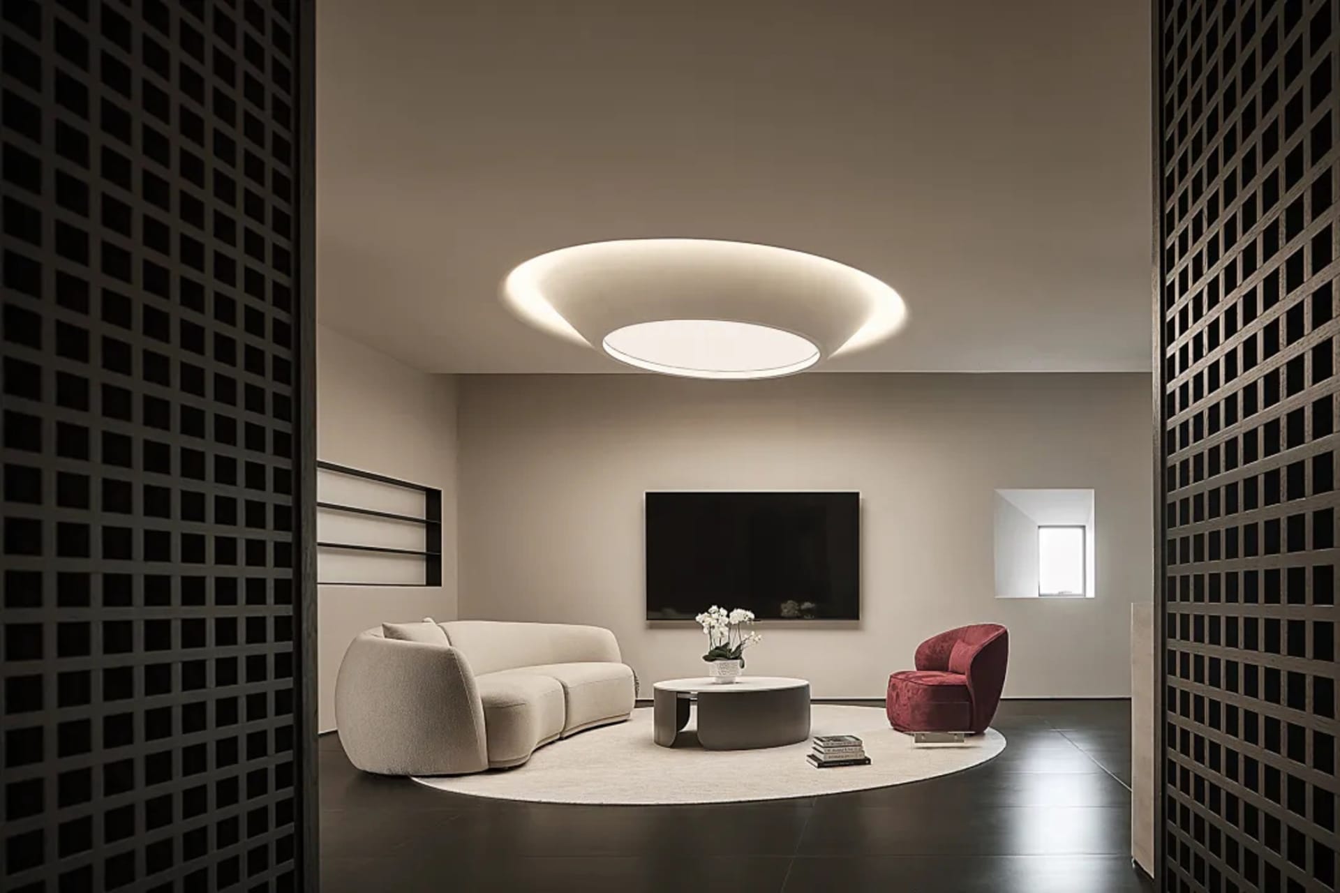 Modern living room featuring a circular lamp, white furniture, and a round coffee table.