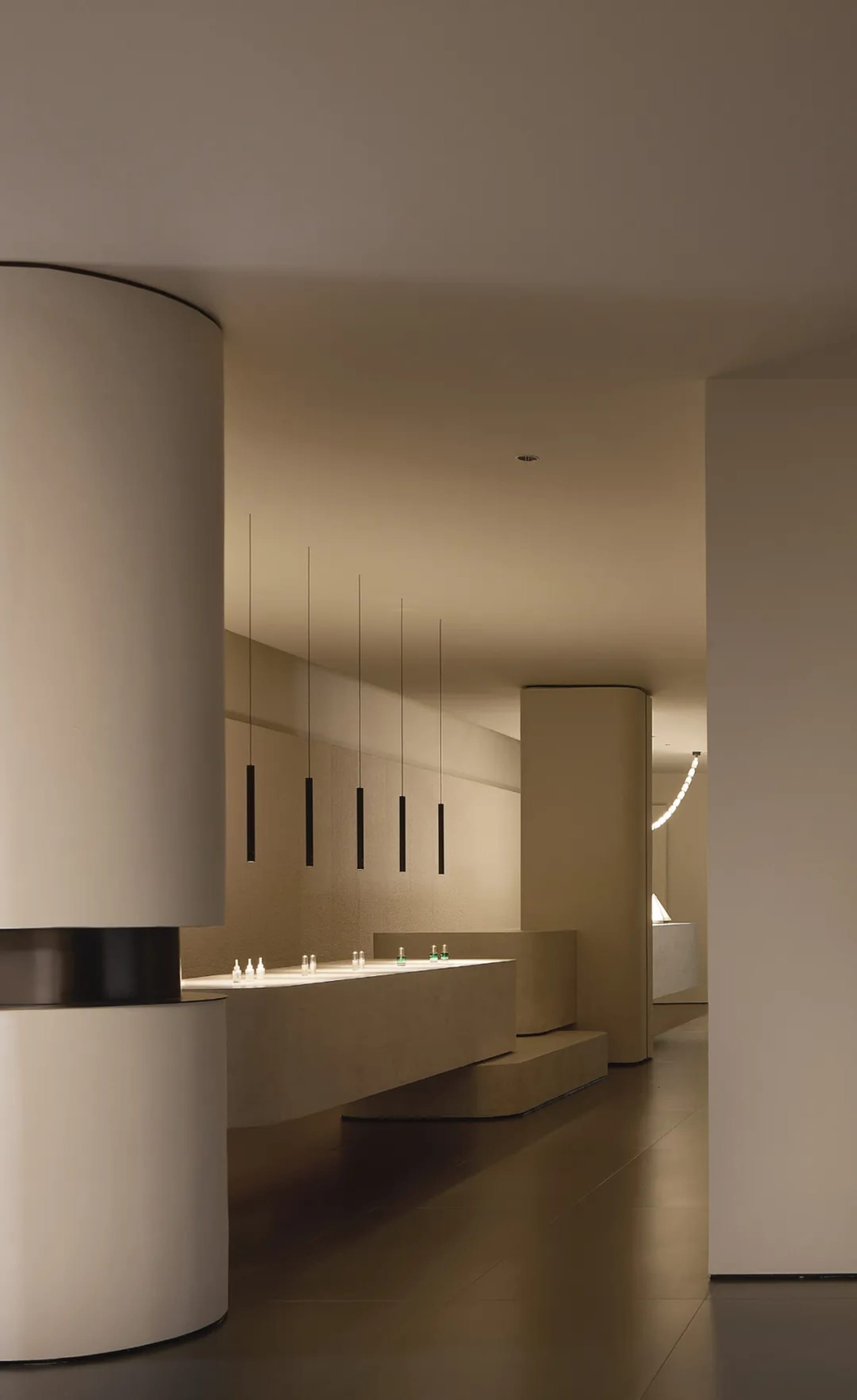 A modern retail storefront featuring minimalist design and concrete finishes.