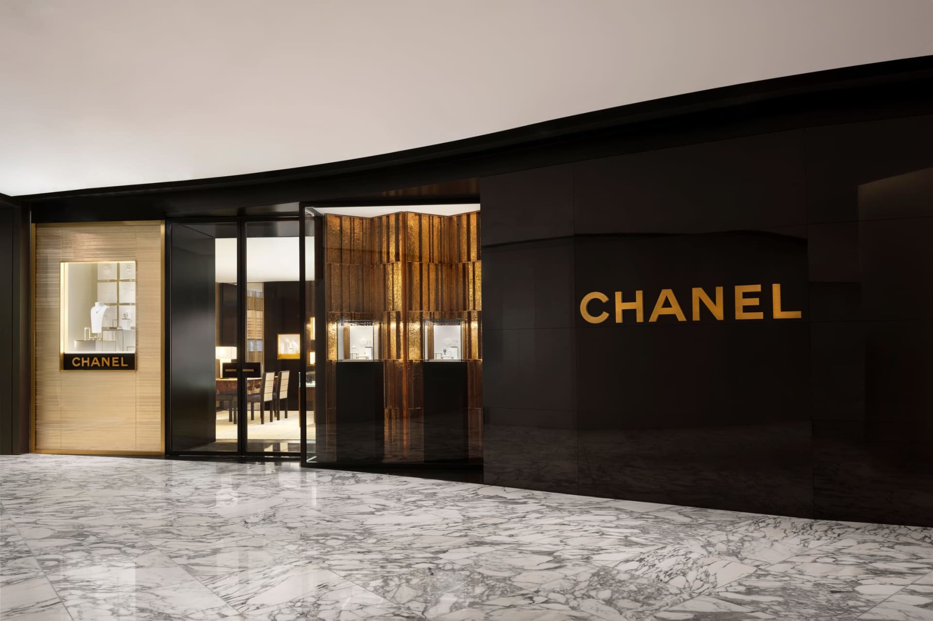 Modern retail storefront featuring sleek glass and gold interior design