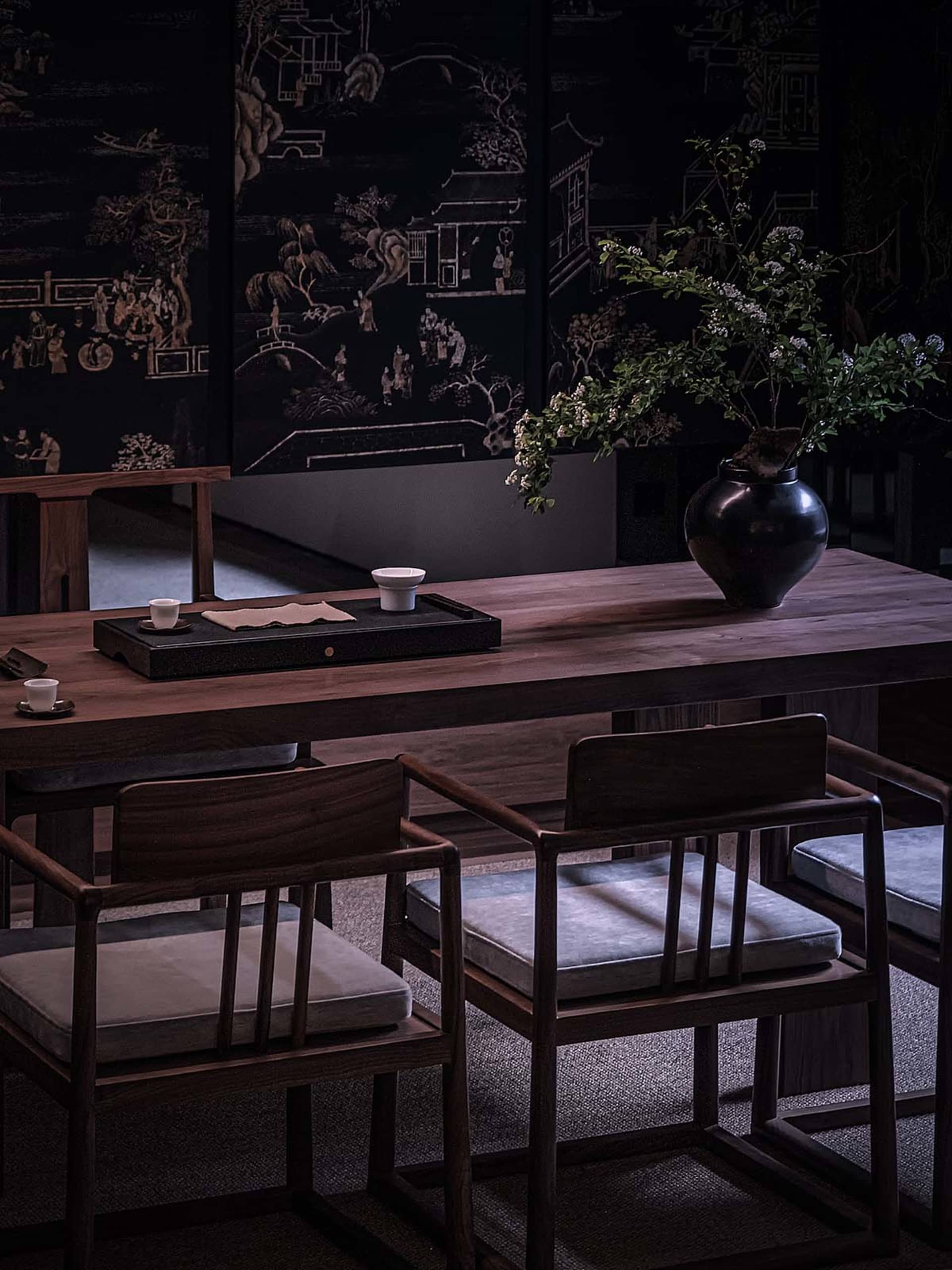 A cozy coffee shop interior with wooden furniture and decorative plants.