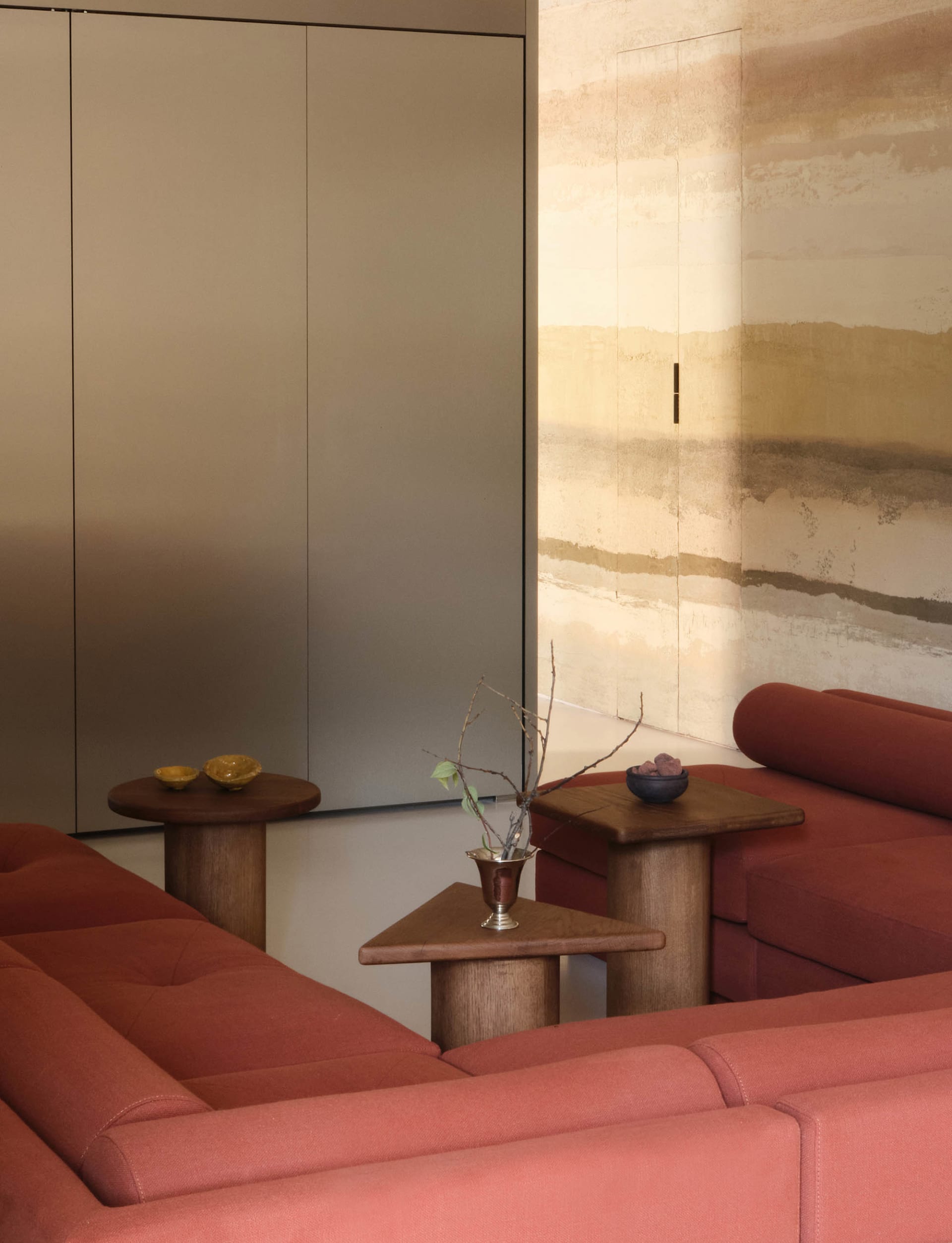 Modern sofa in a minimalist living room with a fabric upholstery and wooden furniture.