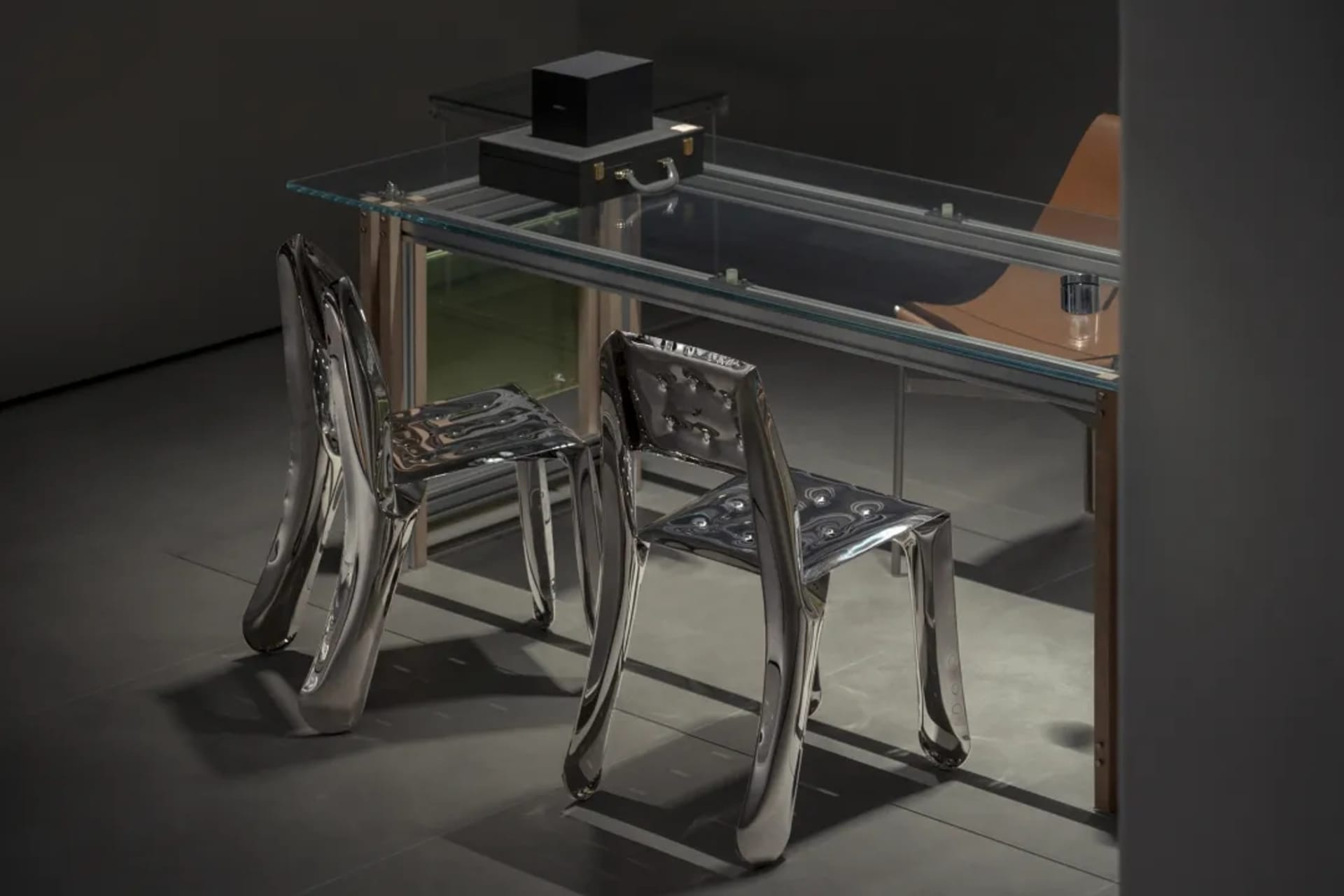 A sleek, modern interior featuring metal furniture with a futuristic design.