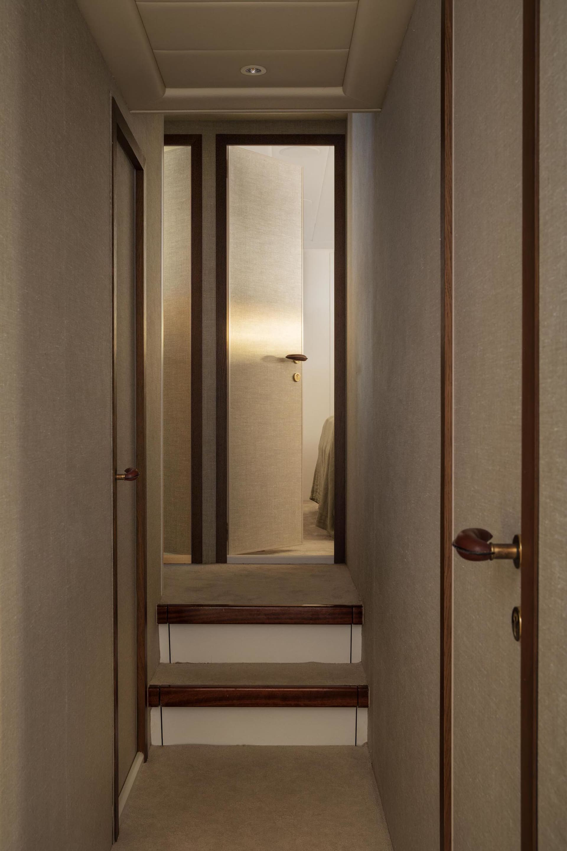 A modern staircase with white steps and wooden edges.