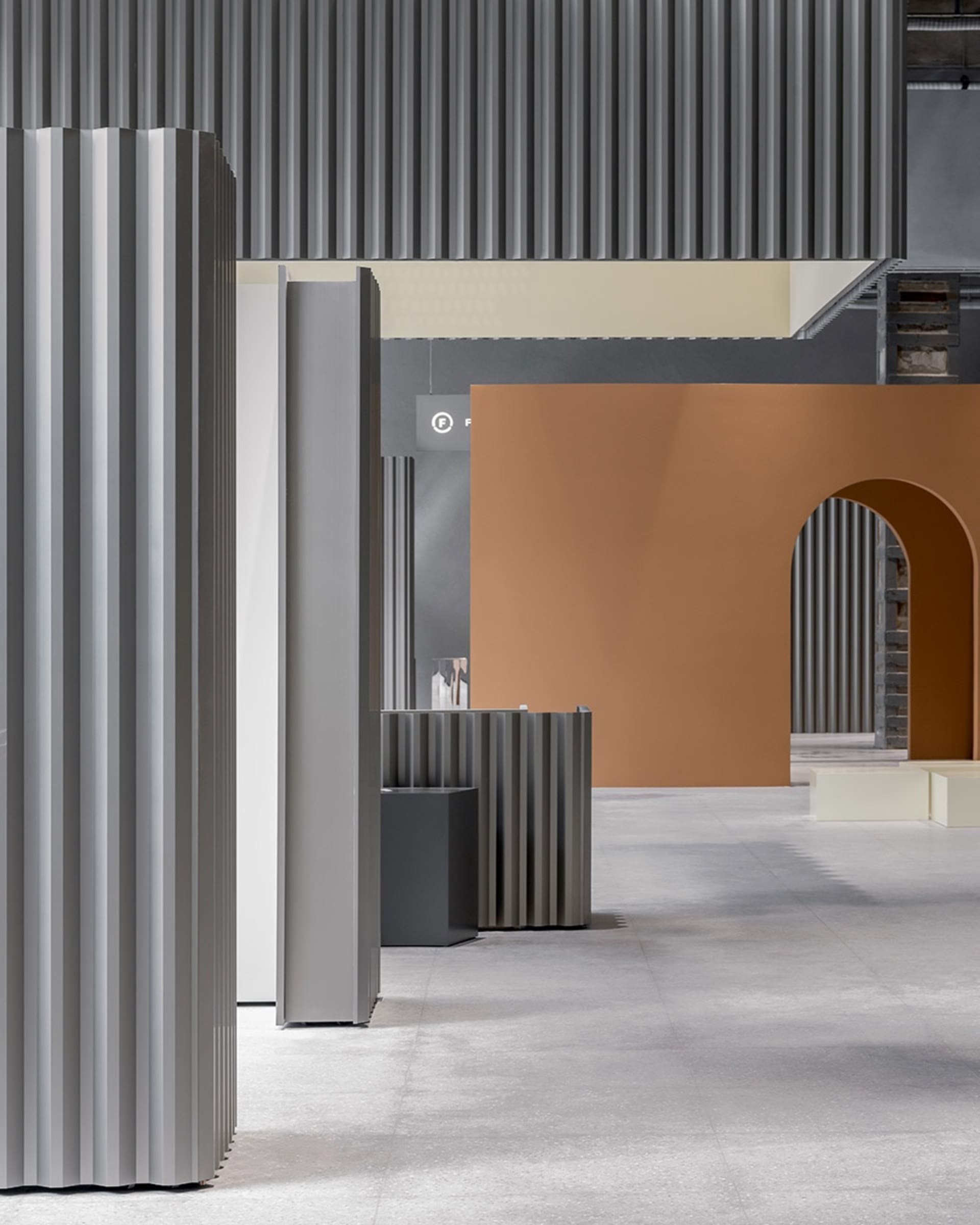 Modern retail storefront featuring metallic corrugated architectural elements