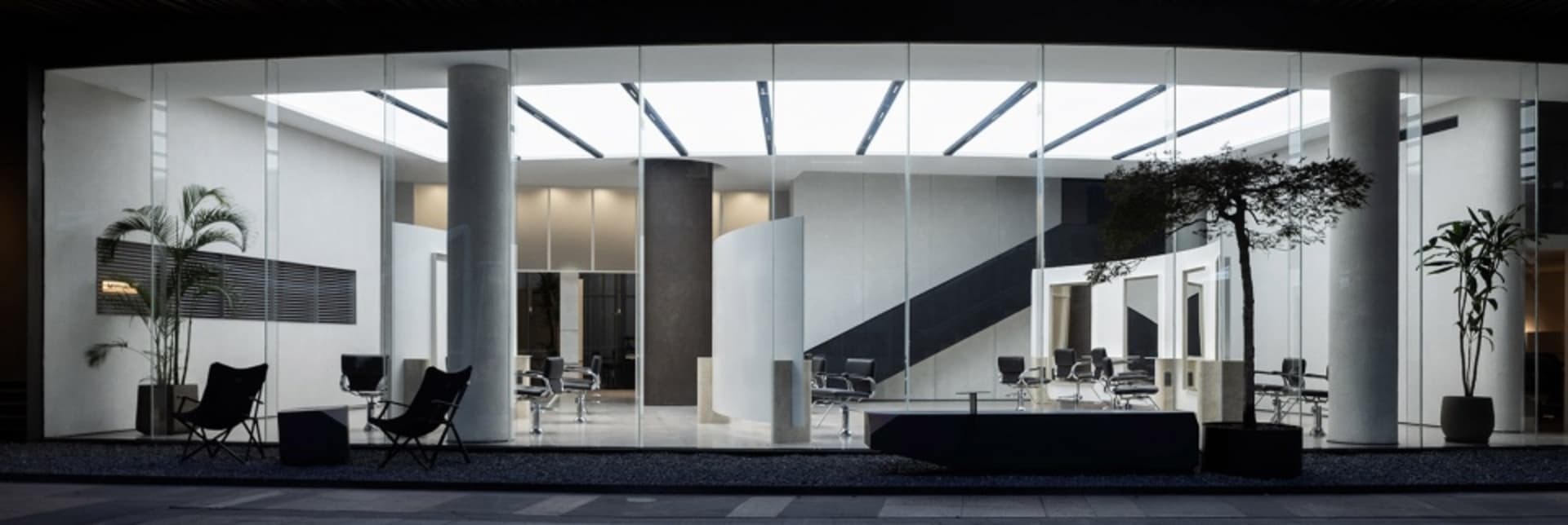 A modern office with a glass wall providing natural light.