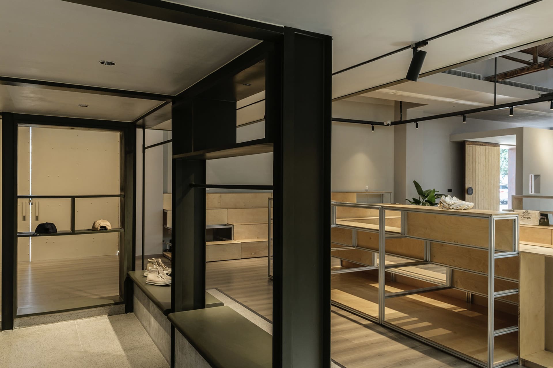 Minimalist retail store showcasing wooden shelves and metal railings