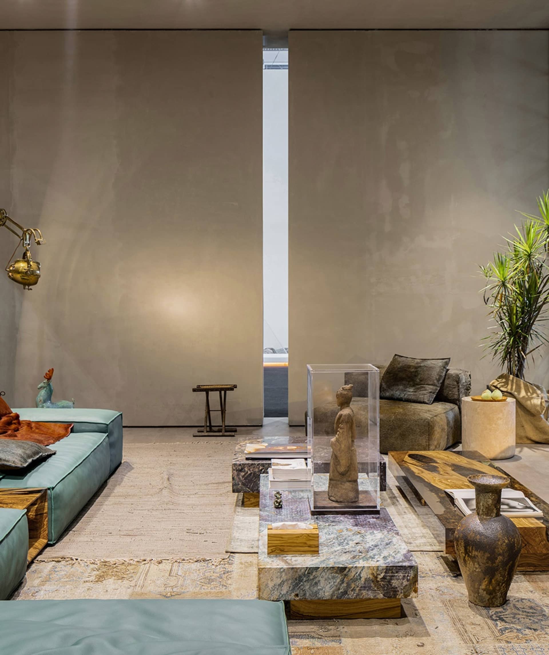 A modern living room featuring marble furniture and decorative elements.