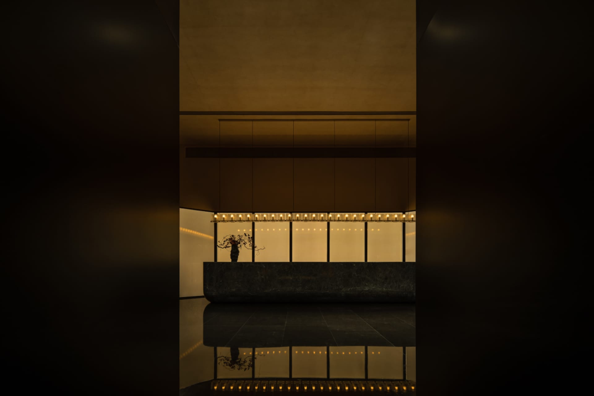 A modern lobby featuring marble and concrete elements.