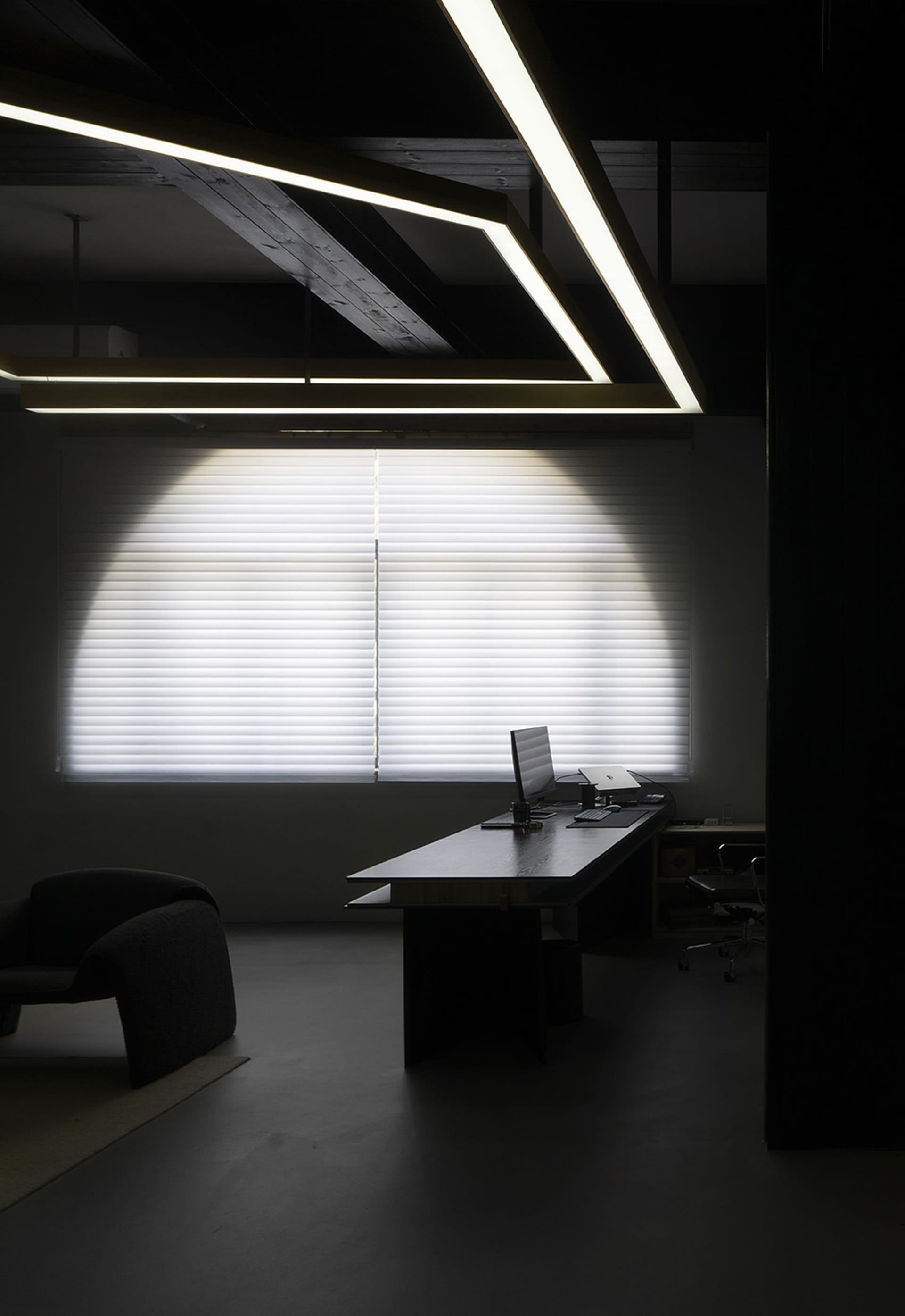 A modern office space featuring glass and concrete elements.
