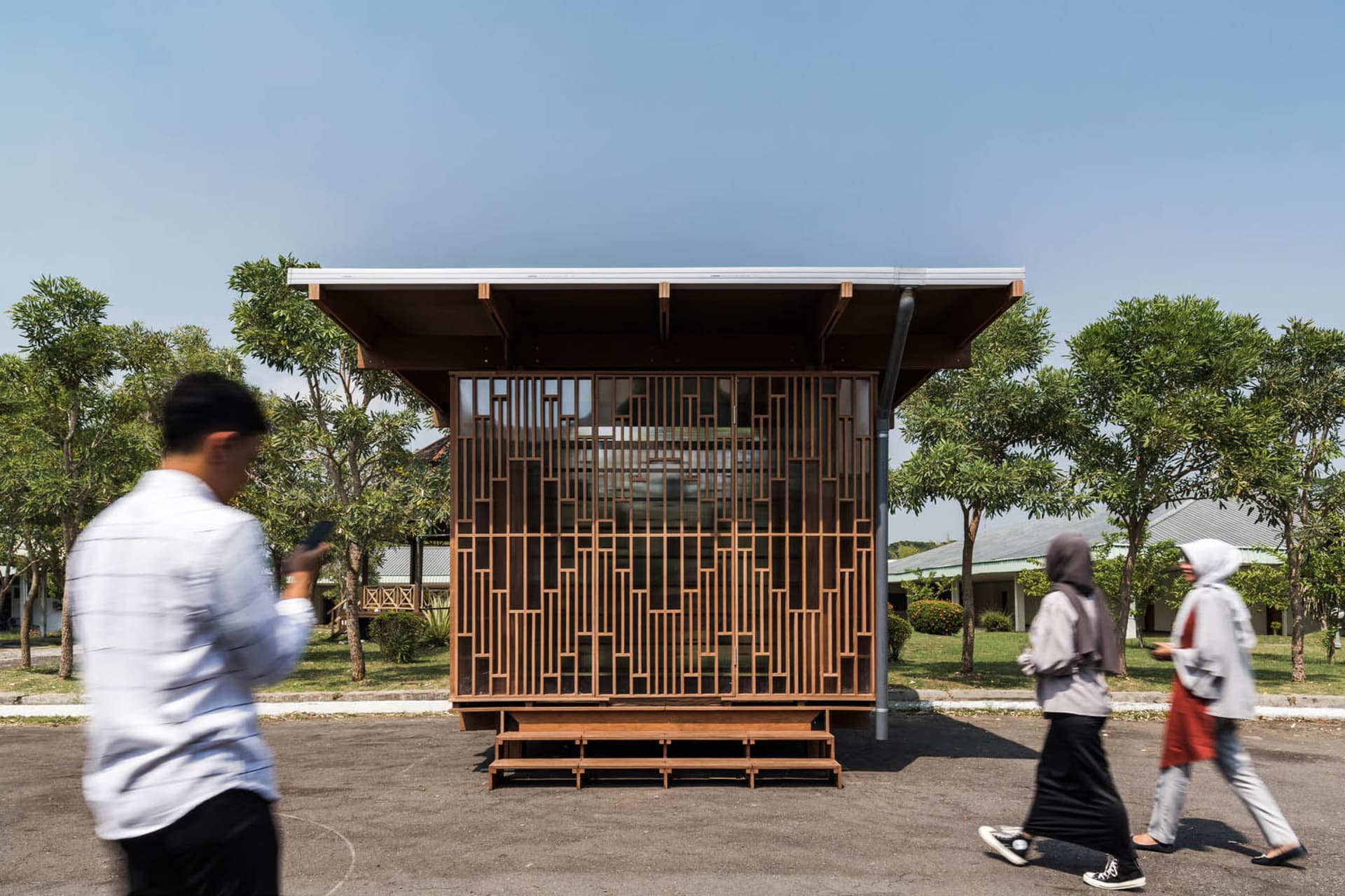 A minimalist modern office space with wooden and glass elements.
