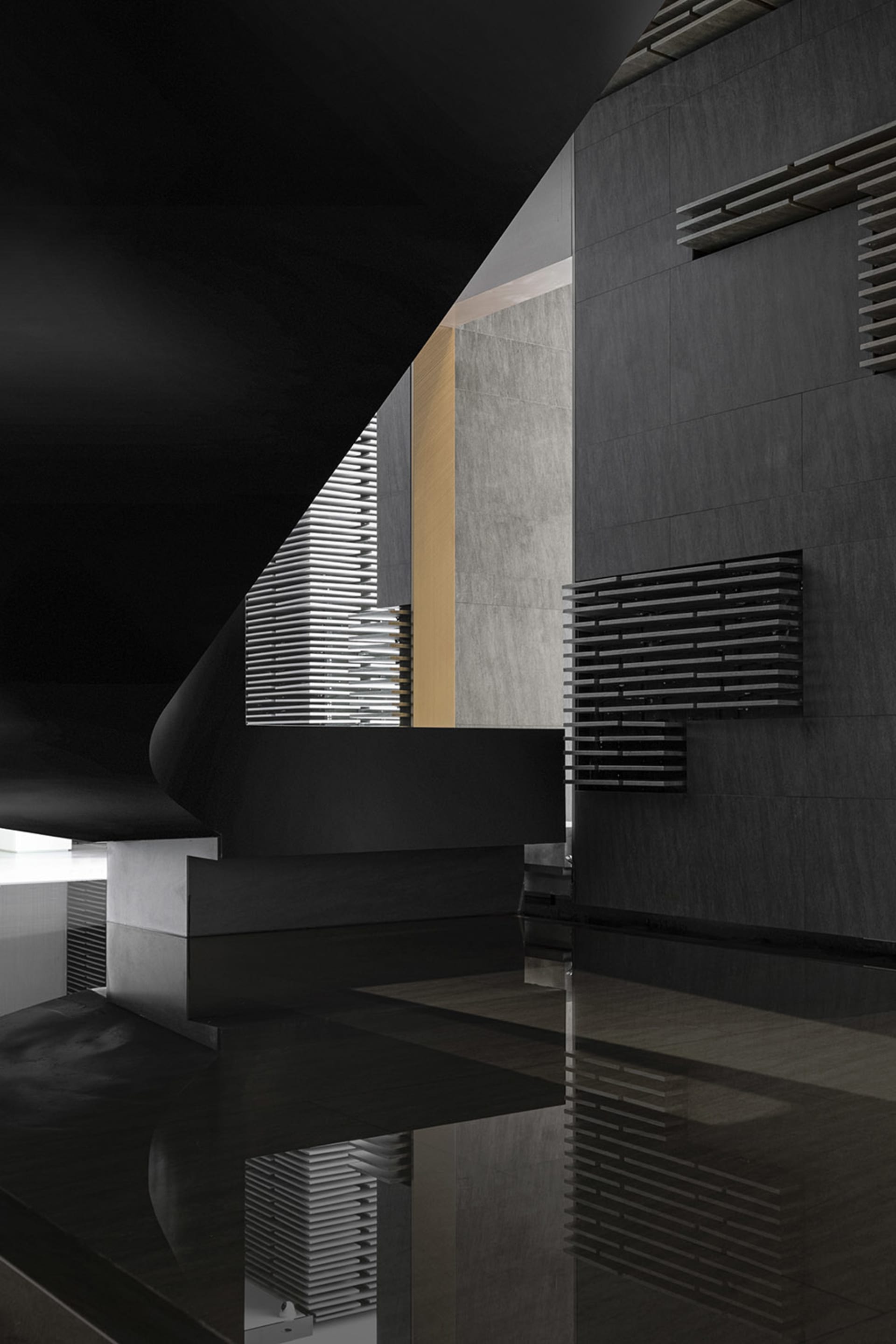 Modern interior space with concrete elements and geometric shapes