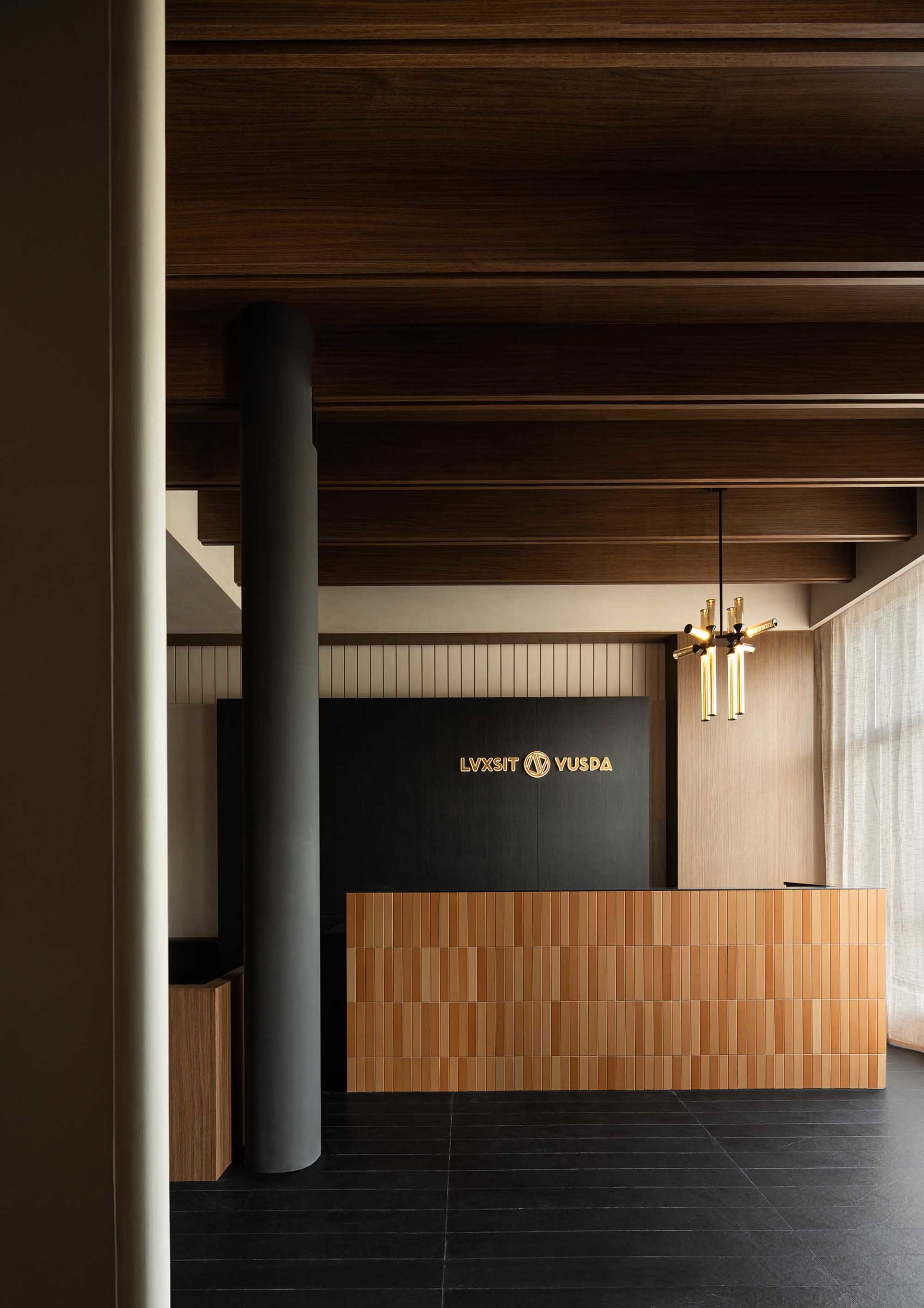 An industrial style office reception desk and counter made of wood tiles with a sign displaying 'LVXSIT YUSPA'.