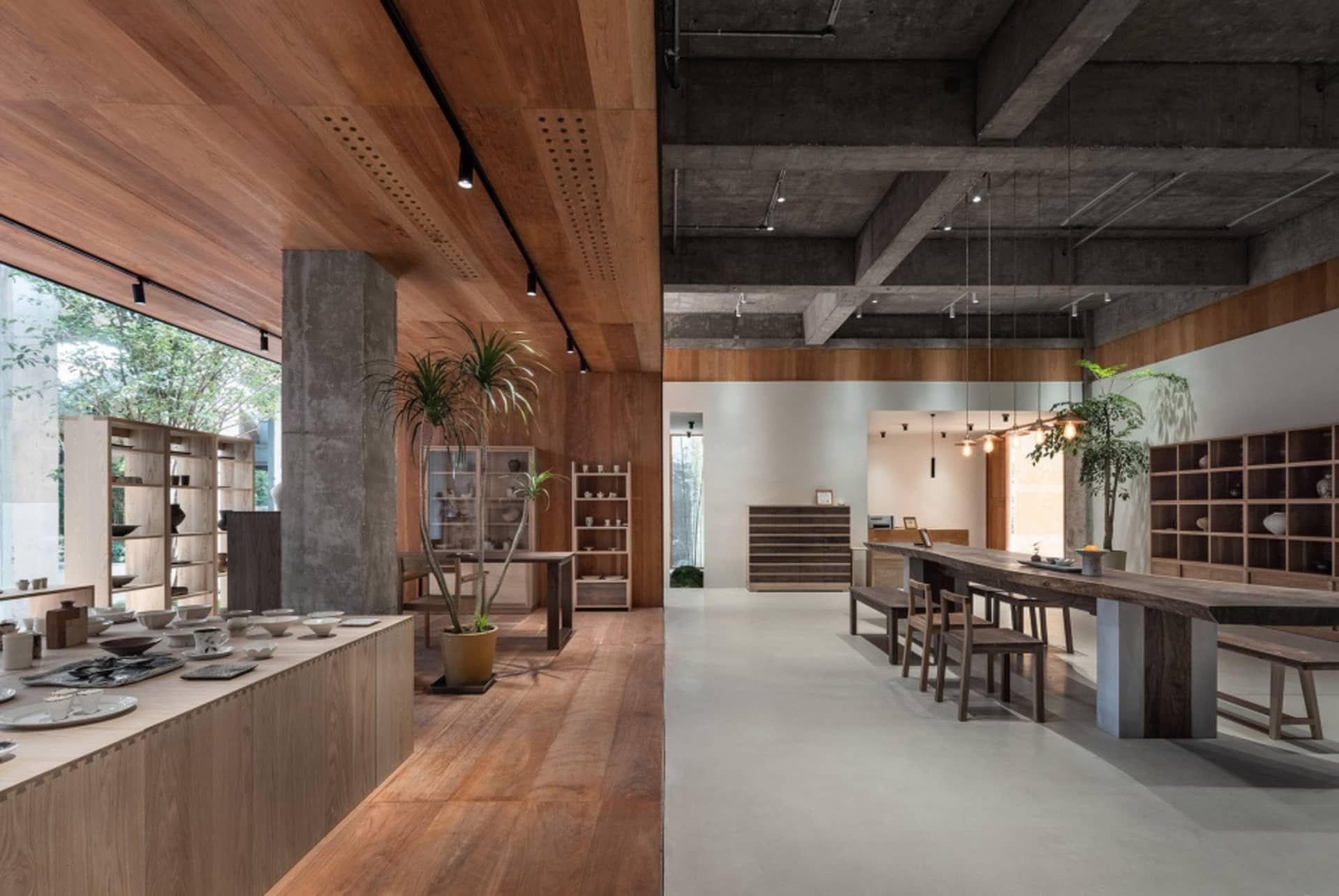 Interior of a minimalist art gallery featuring concrete and wooden elements.
