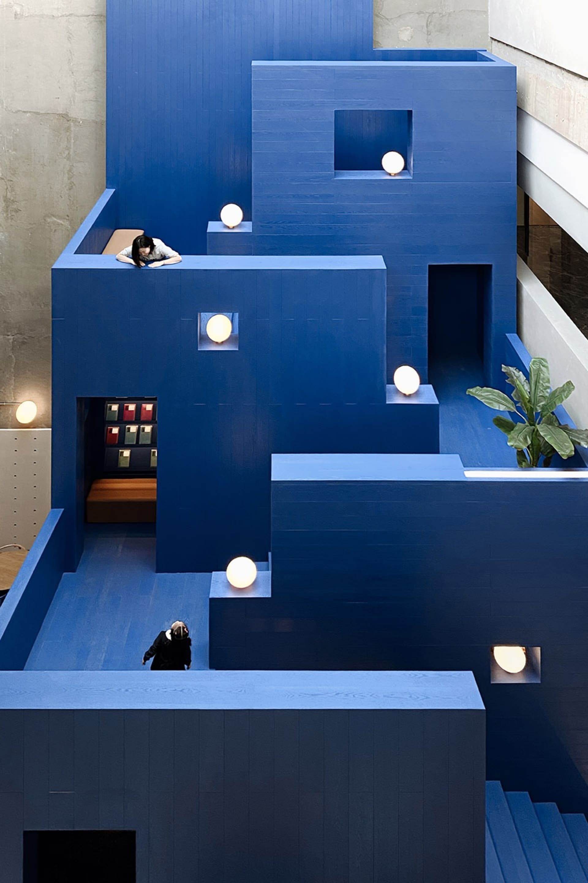A modern interior design featuring blue panel walls and ambient lighting.
