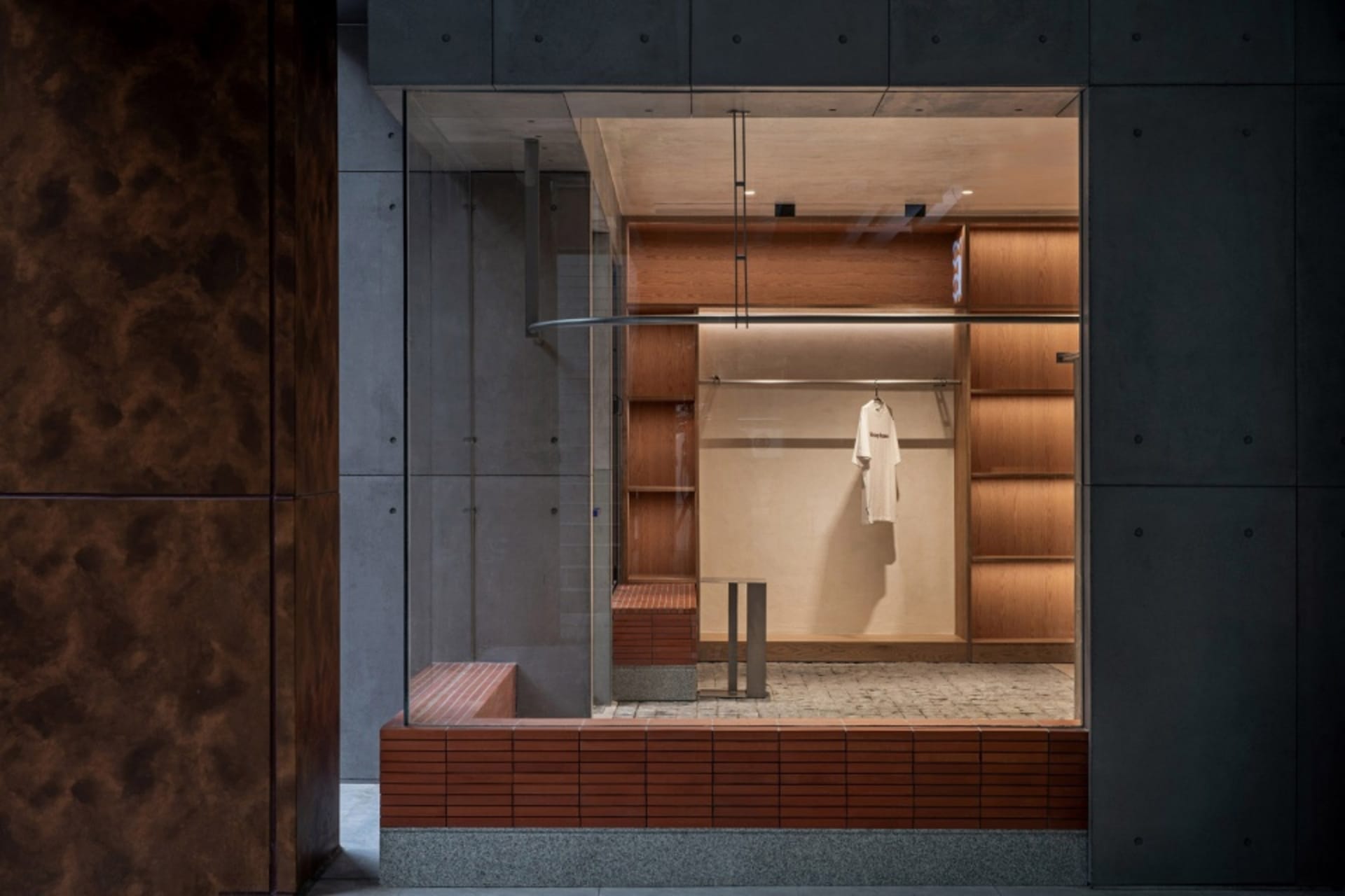 A modern clothing store display featuring wooden accents, showcasing contemporary retail design.