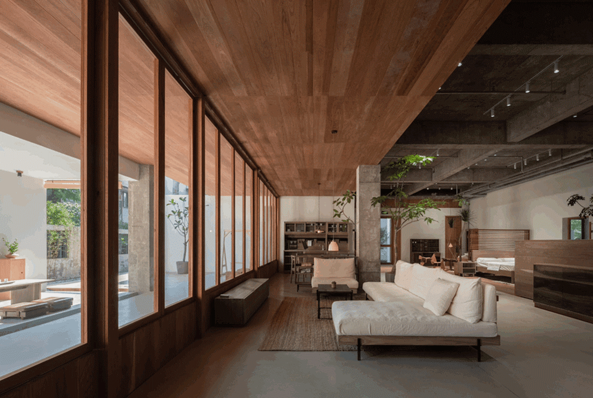 A modern minimalist living room with wood accents and white furniture.