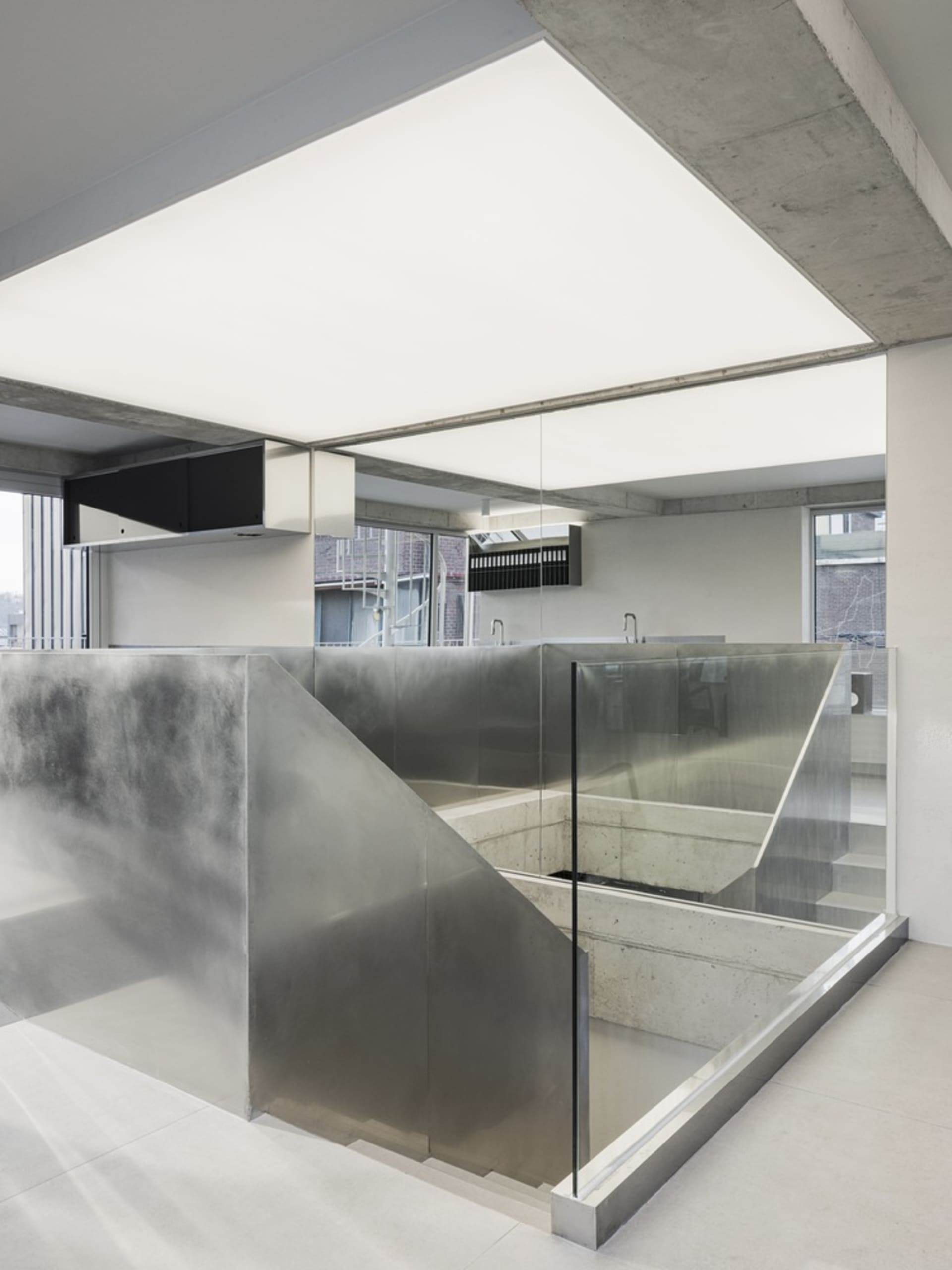 An interior office space featuring modern, minimalist design with concrete elements.