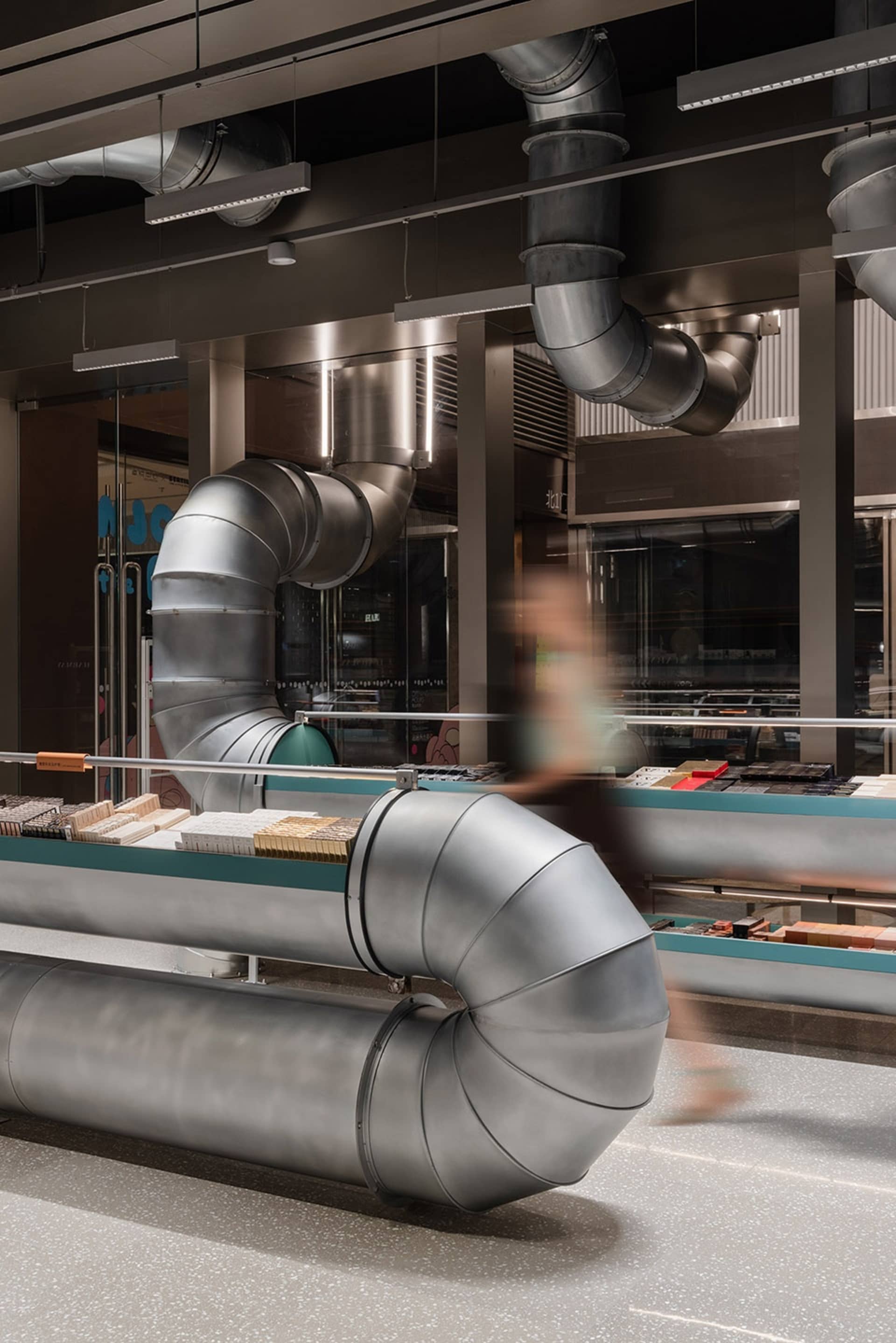 Industrial-style retail space featuring metallic ductwork and concrete flooring.