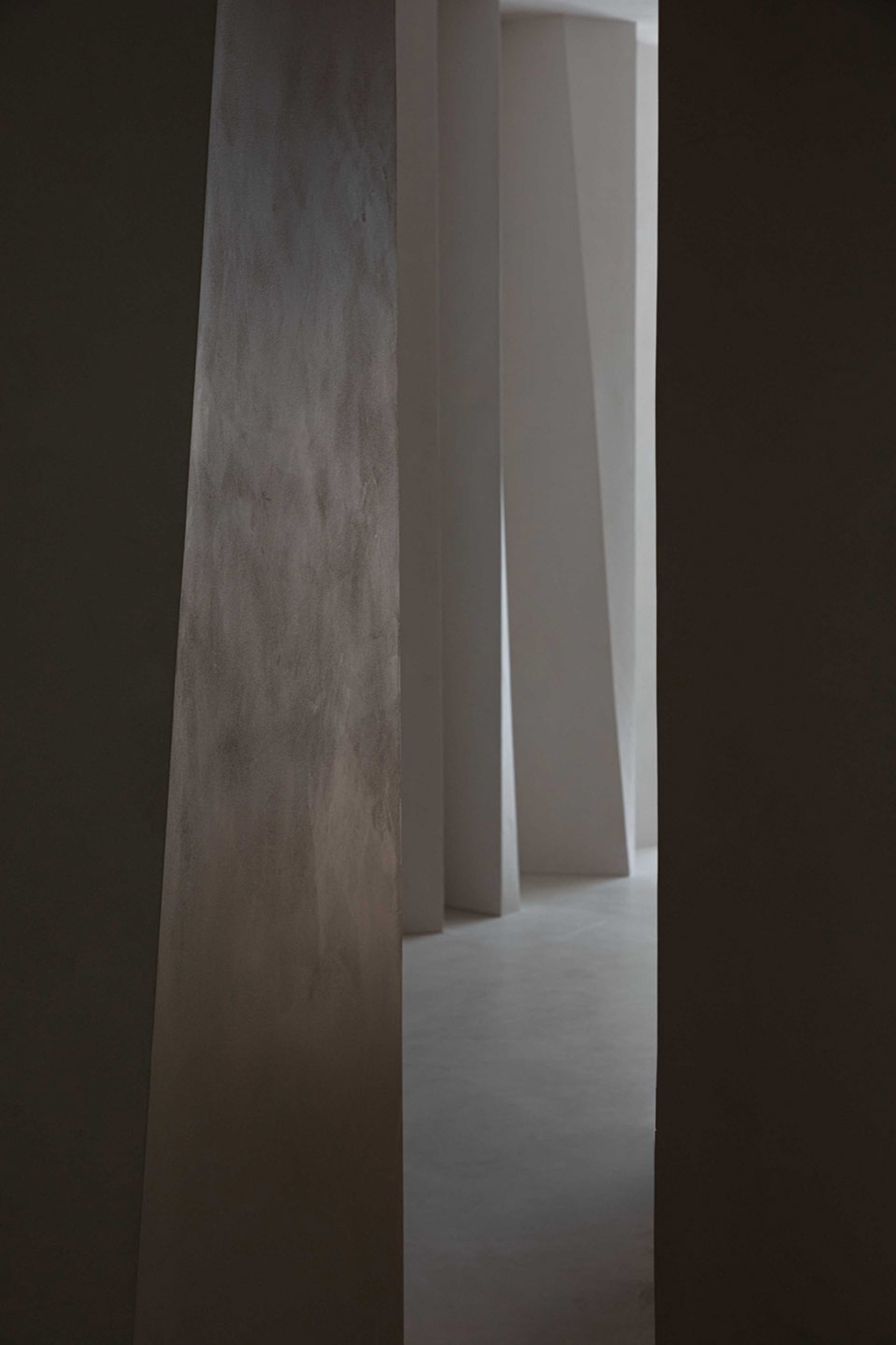 Minimalist modern interior design featuring concrete stones as a primary material.
