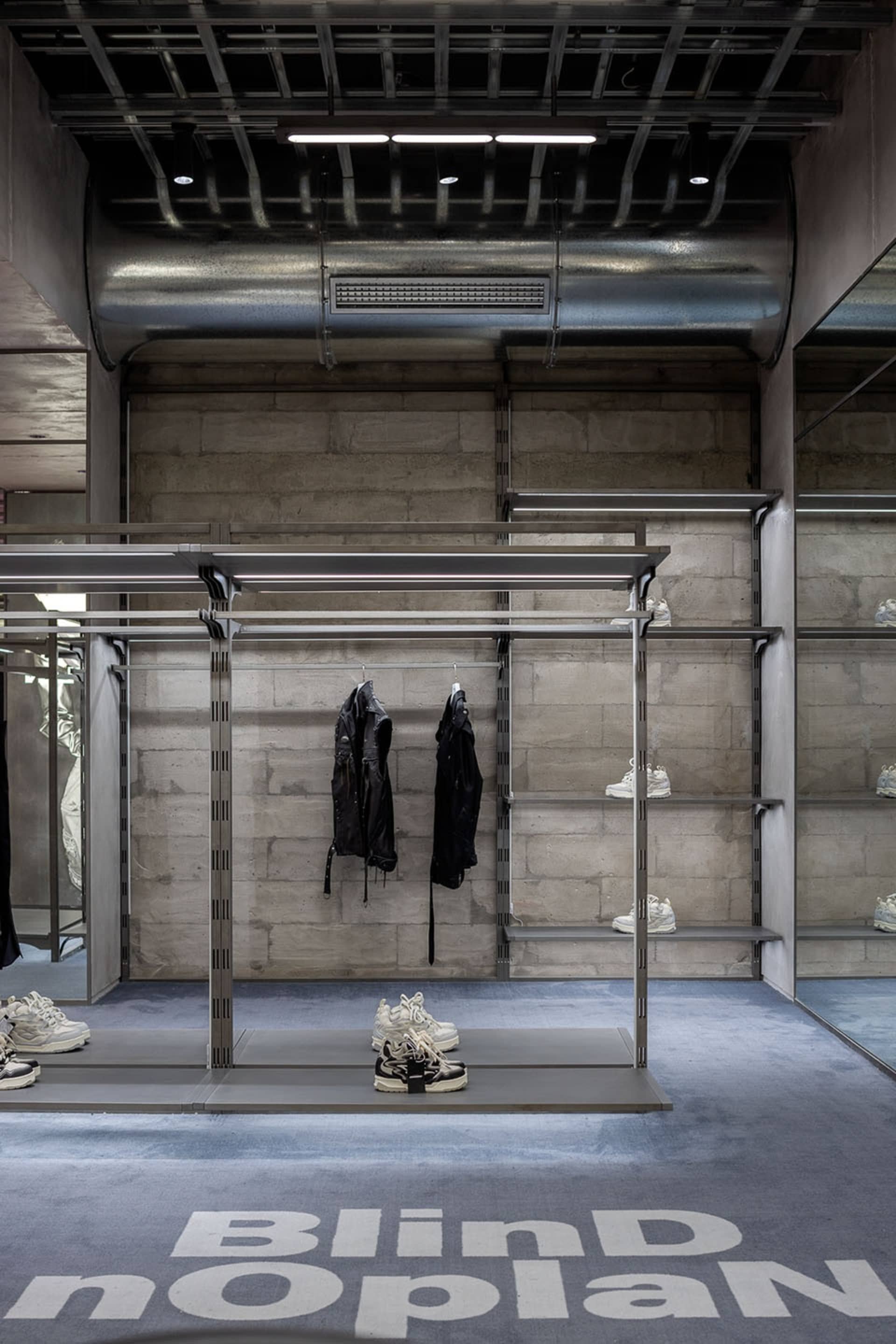 Metal shelving and hangers for displaying shoes in a retail environment.