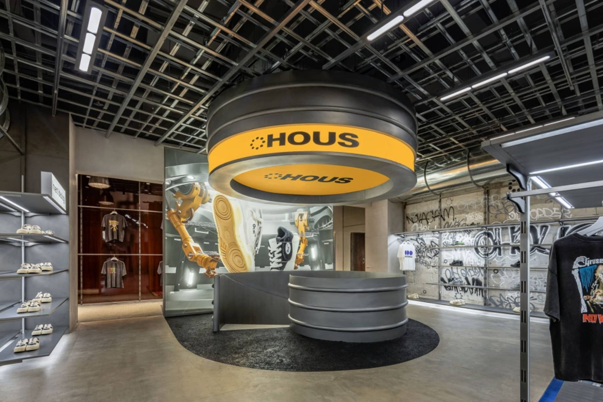 Industrial-themed retail store with concrete and glass materials, featuring metallic accents and a minimalist design.