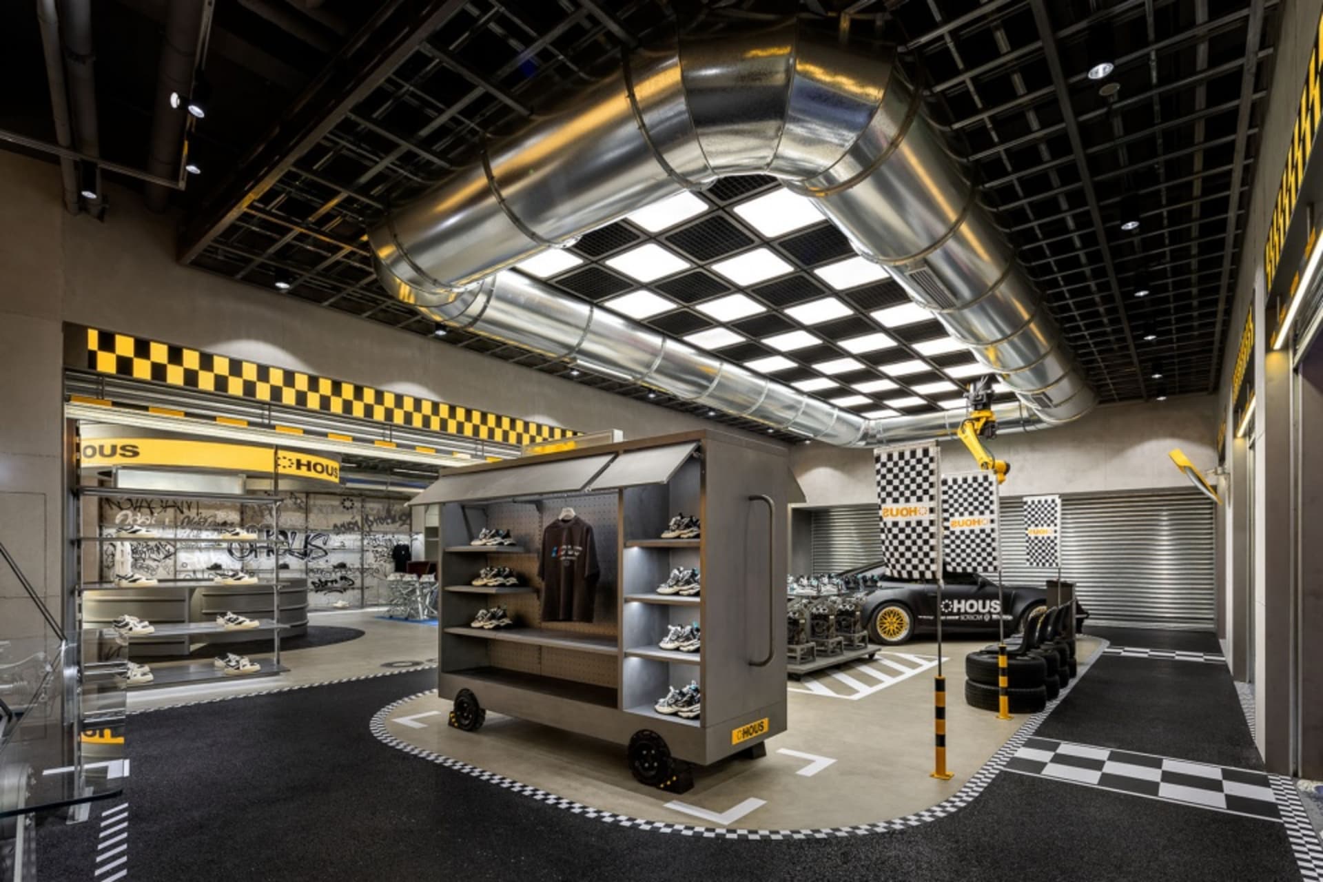 Industrial-themed retail store with metal shelving, concrete flooring, and glass displays.