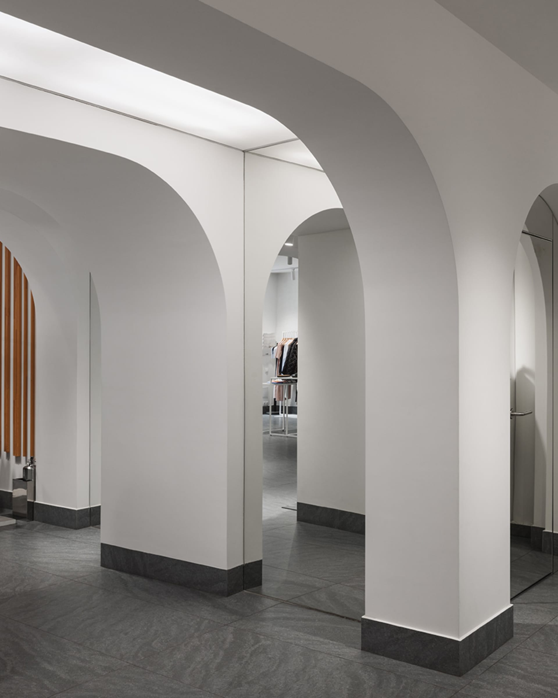 Modern retail store with minimalist design and concrete walls and floors.