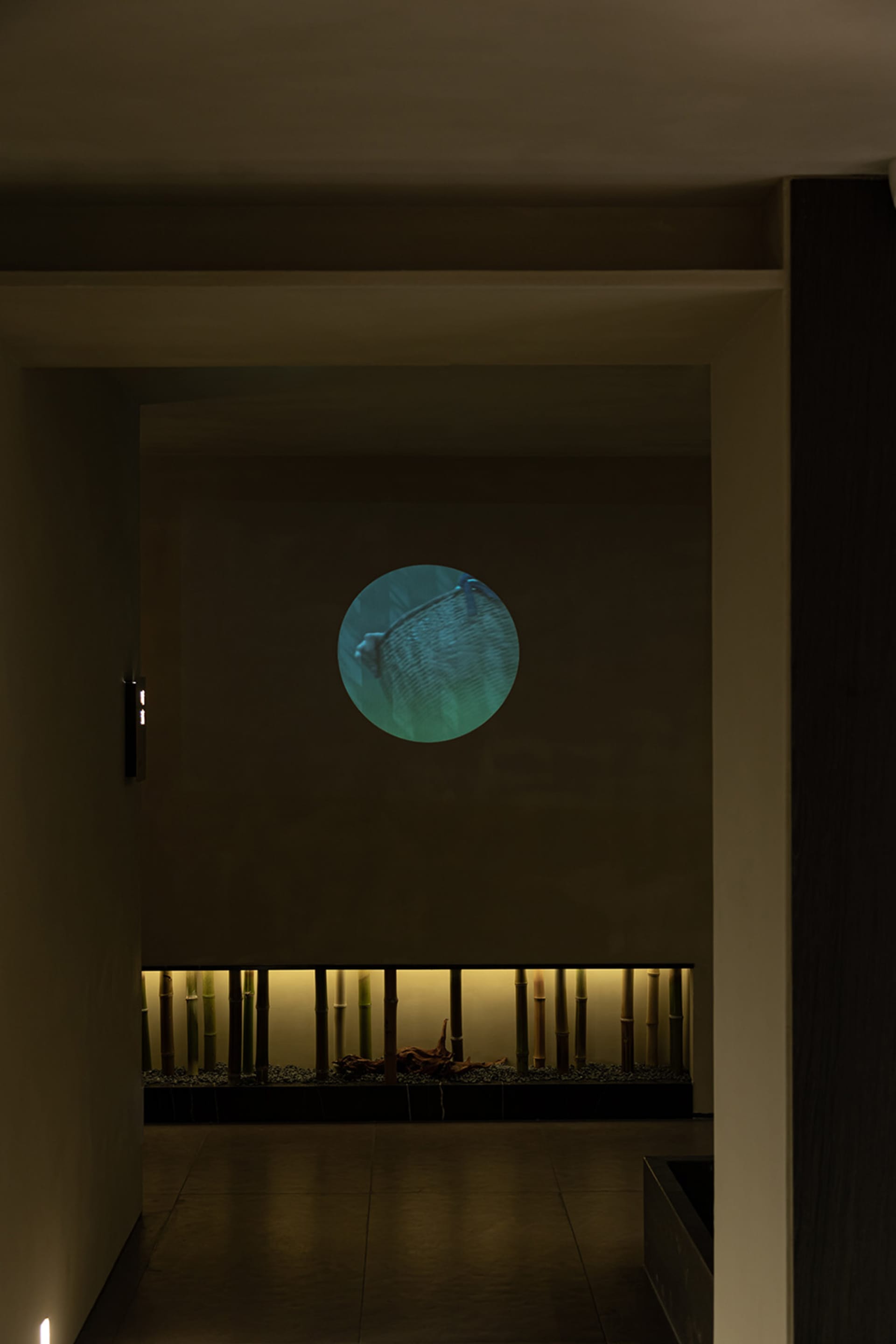 Modern interior design hallway with a backlit round window.