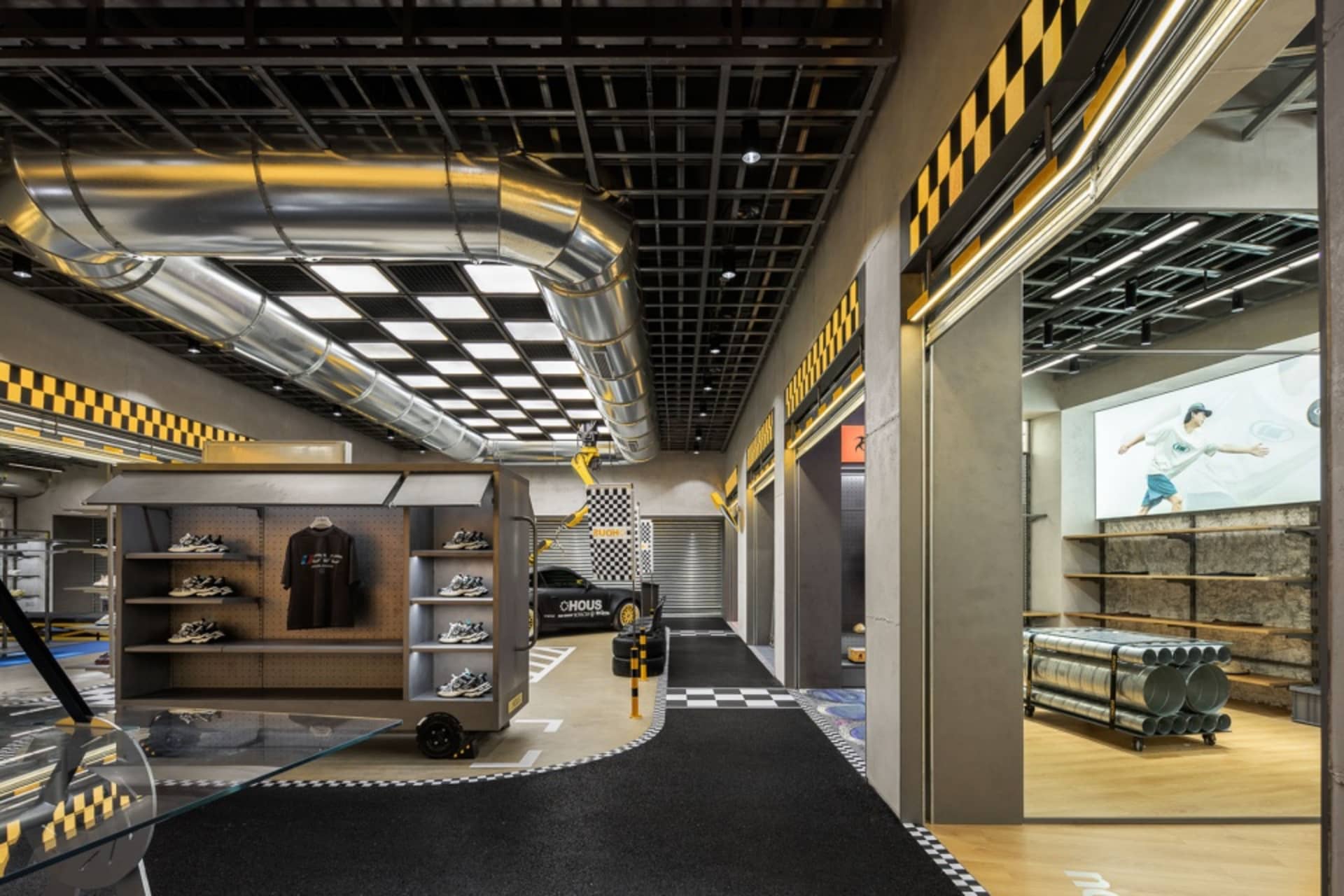 現代零售室內以金屬與混凝土元素打造,展示玻璃陳列櫃的鞋履店,帶有工業風格