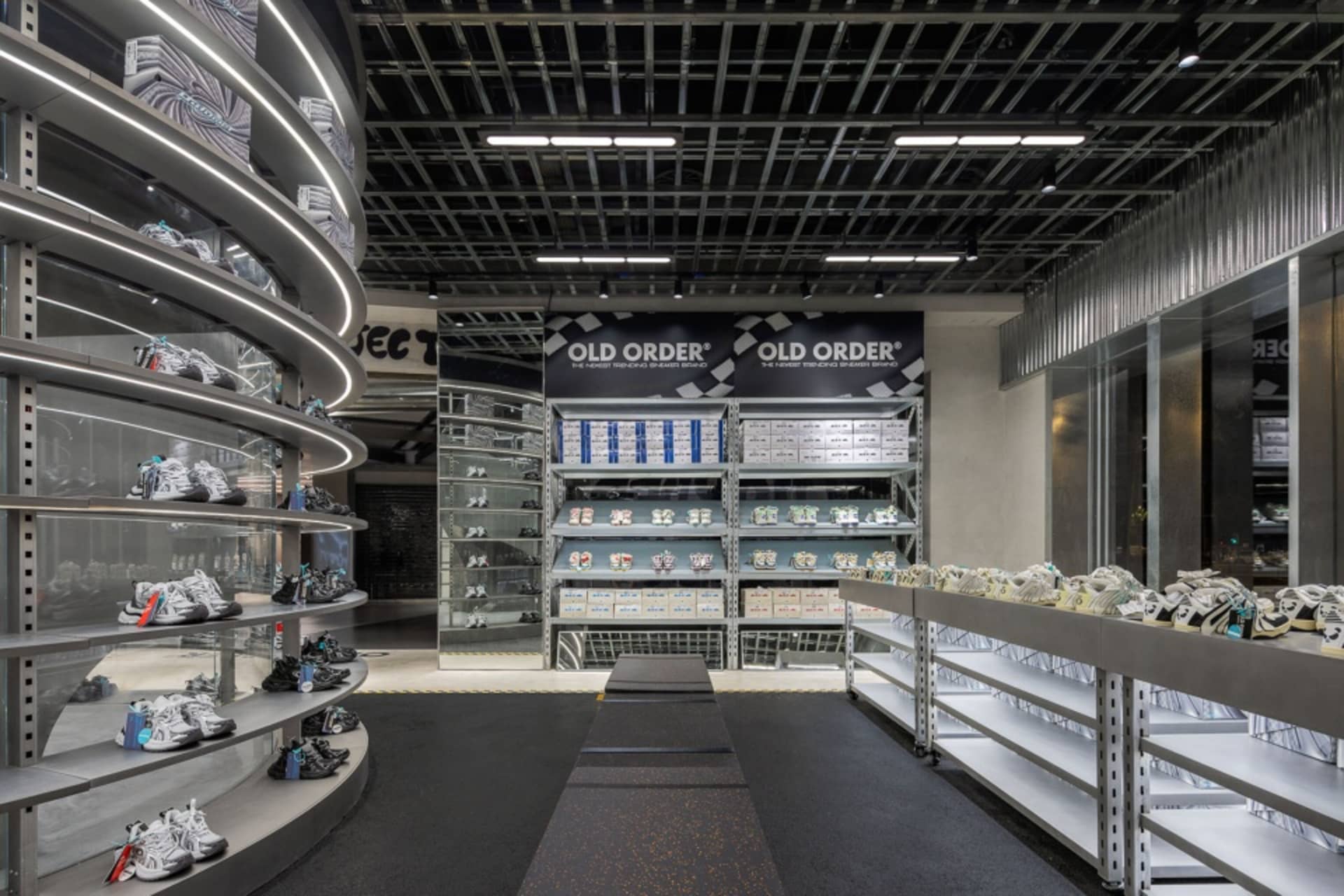 An interior view of a retail shoe store showcasing a variety of shoes on display.