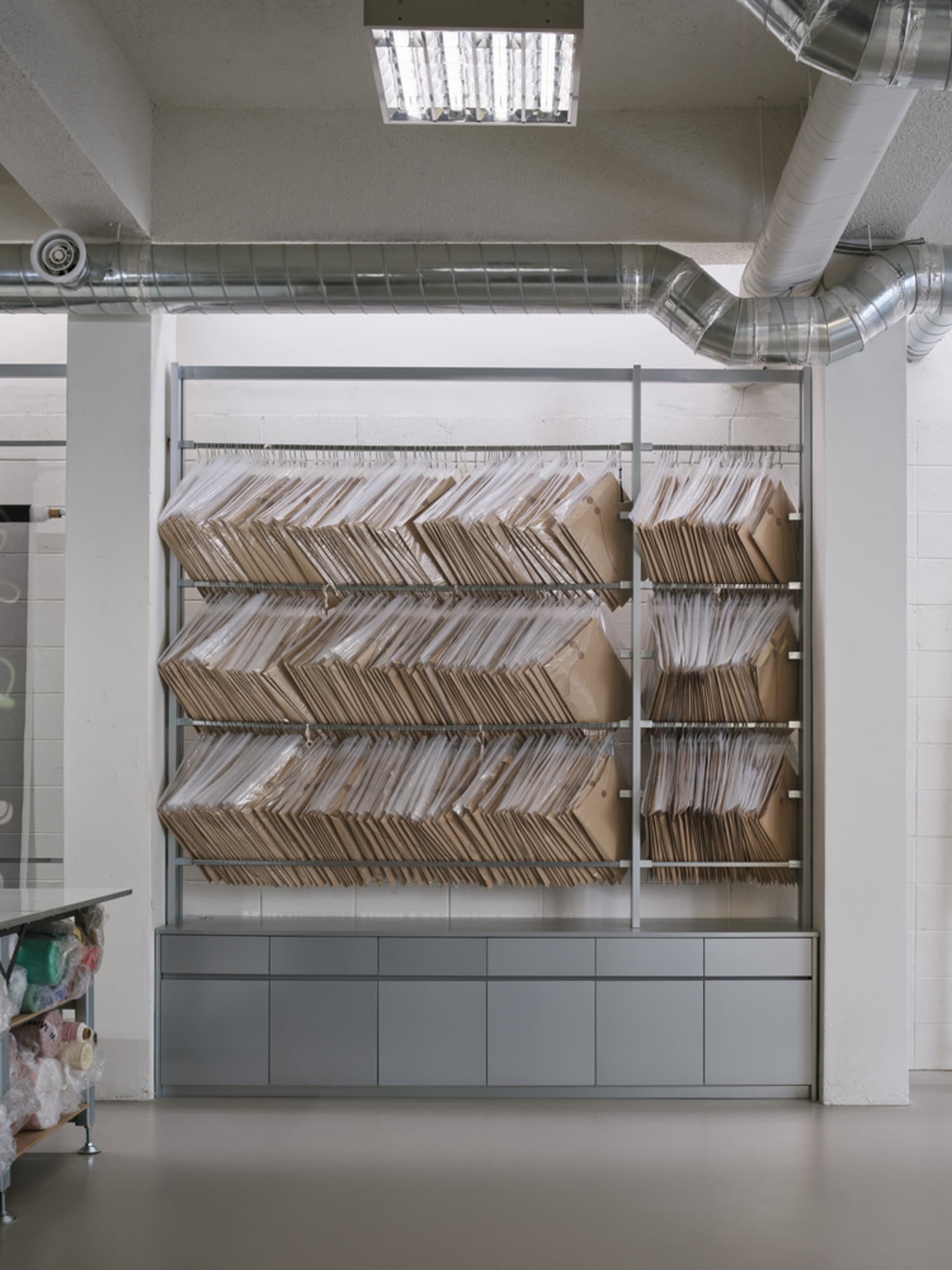 Large industrial storage rack filled with cardboard boxes in a warehouse setting.