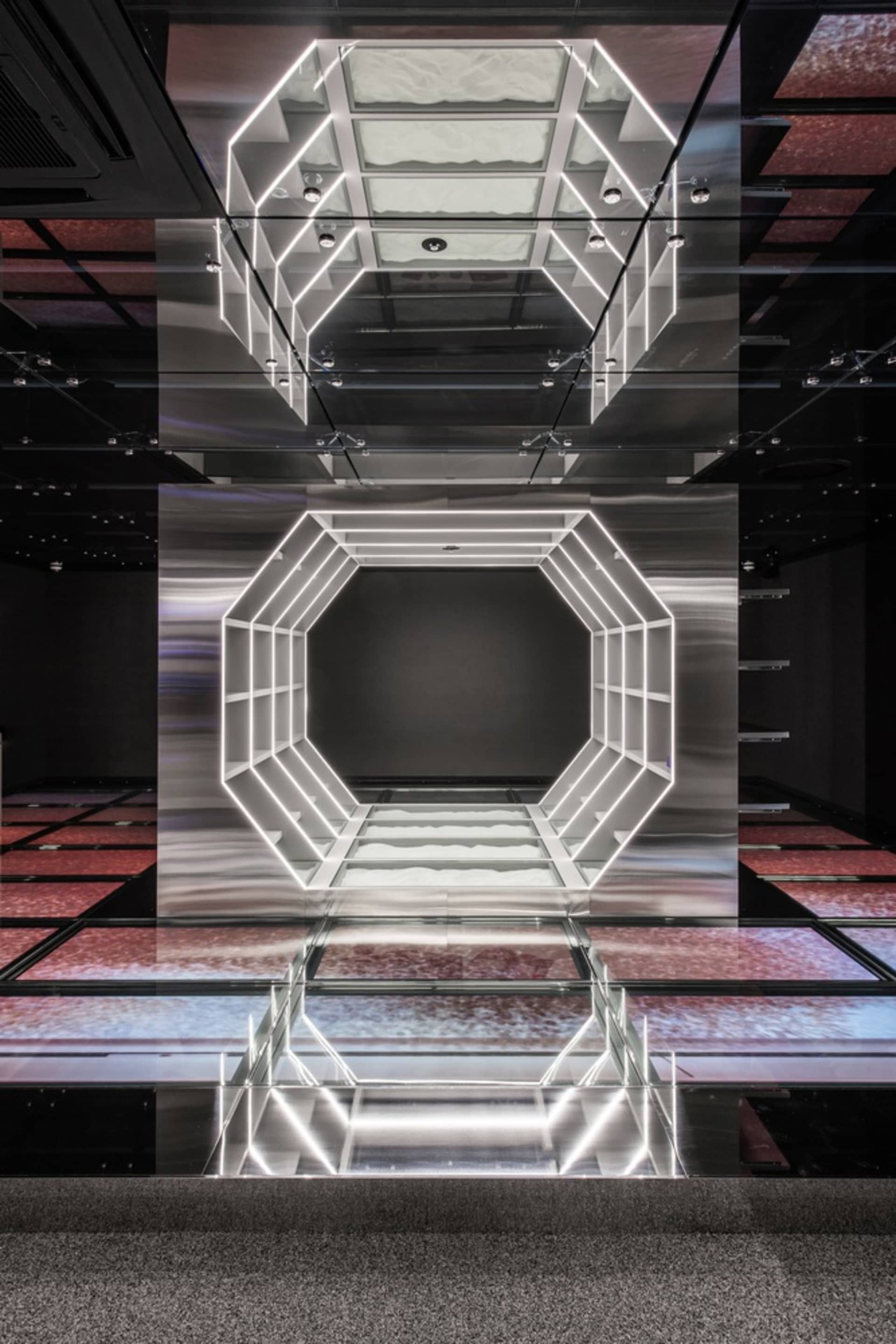 An image featuring a minimalist architectural space with glass features.
