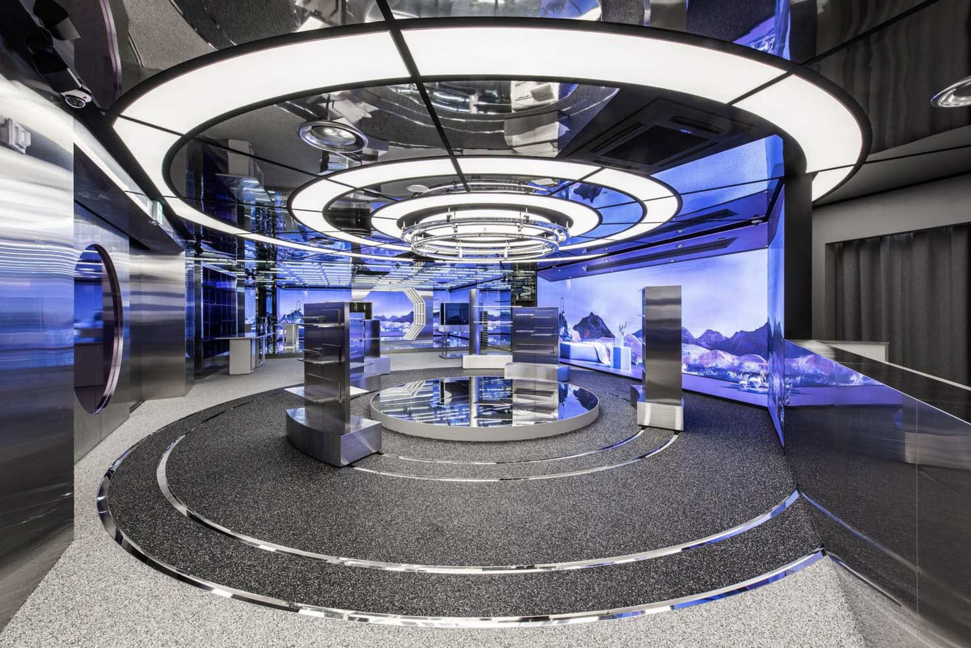 A modern retail shop featuring metallic and glass materials with a futuristic design.