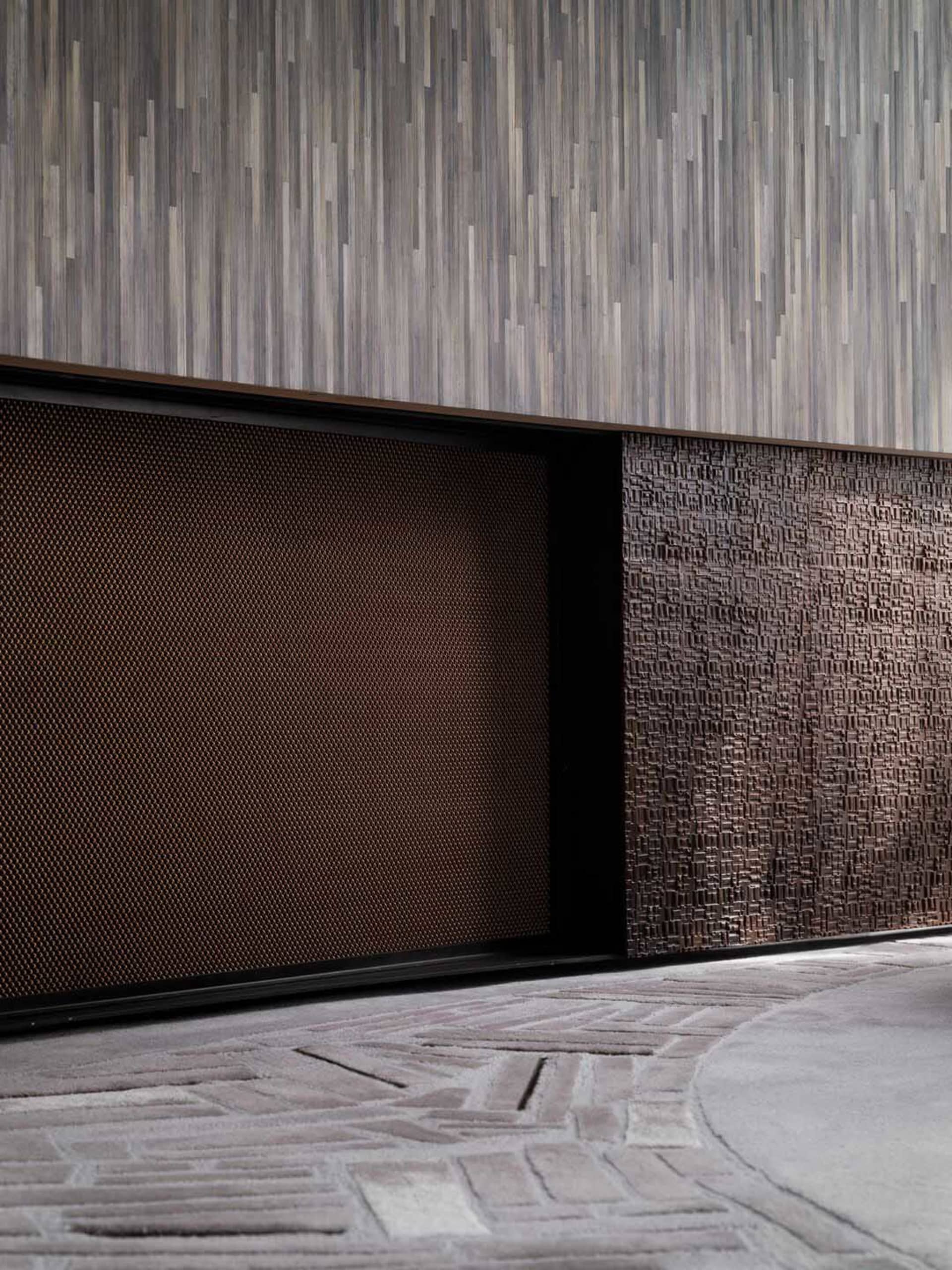 A textured, metal wall panel with a modern design in a contemporary interior space.