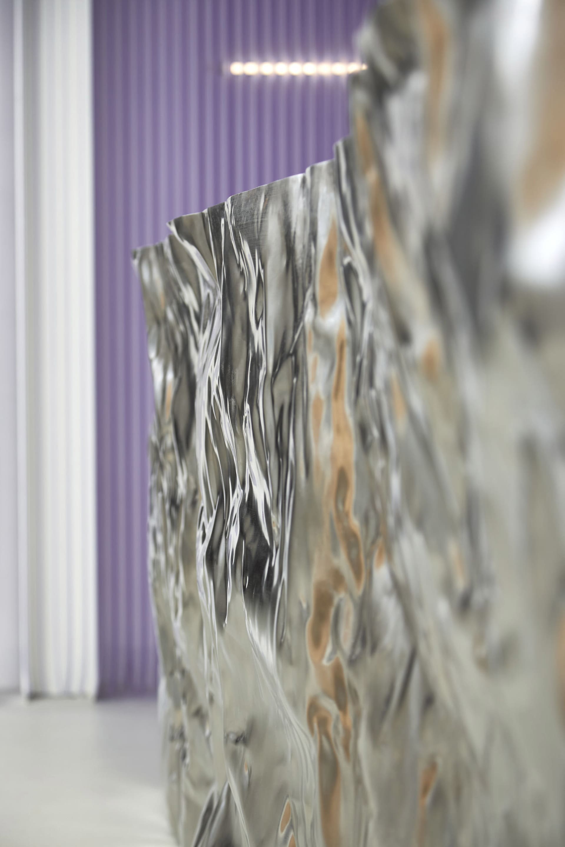 A metallic panel with a modern design and textured surface.