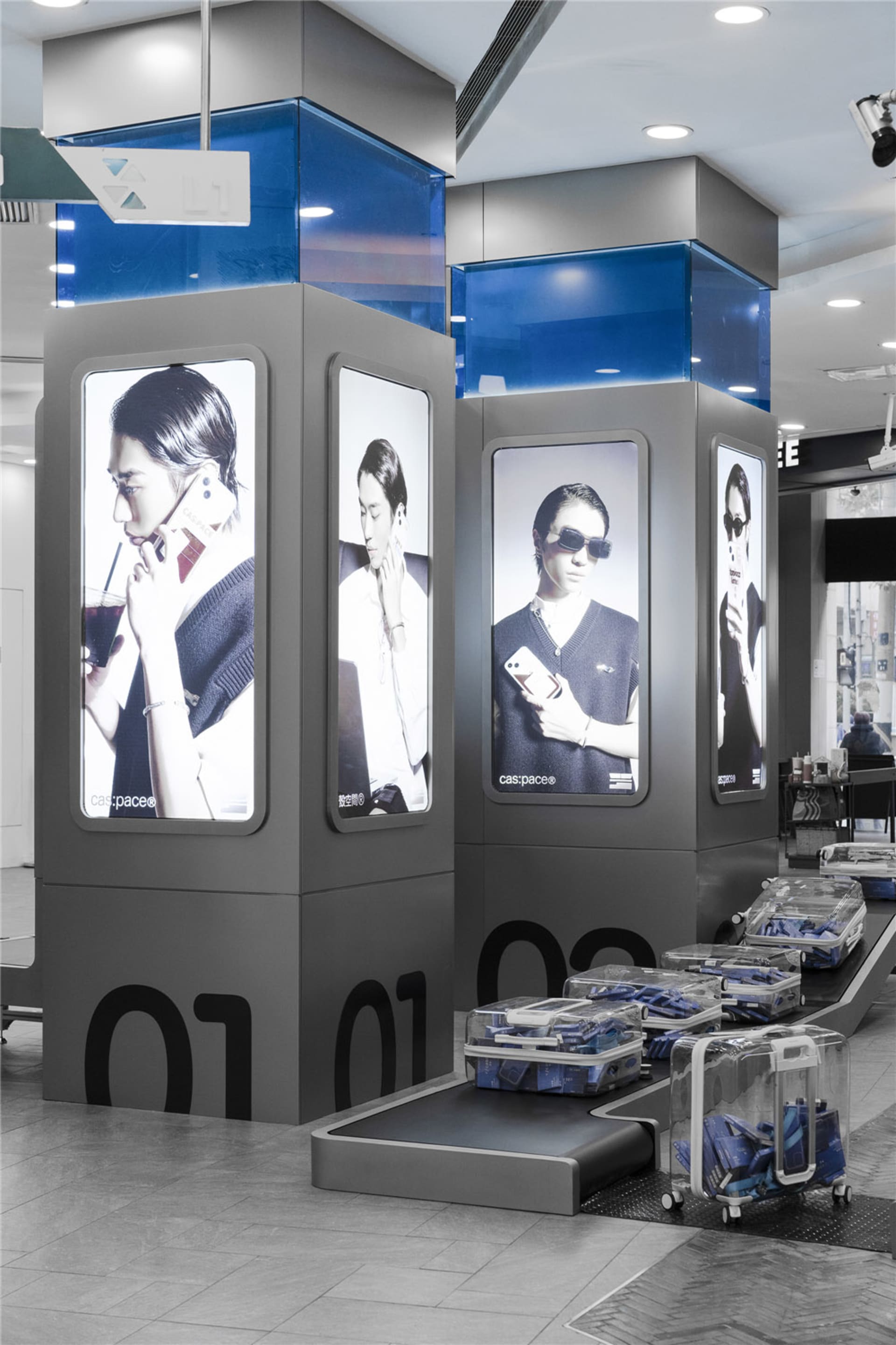 A retail advertisement featuring images of people holding phones, displayed on a modern stand.