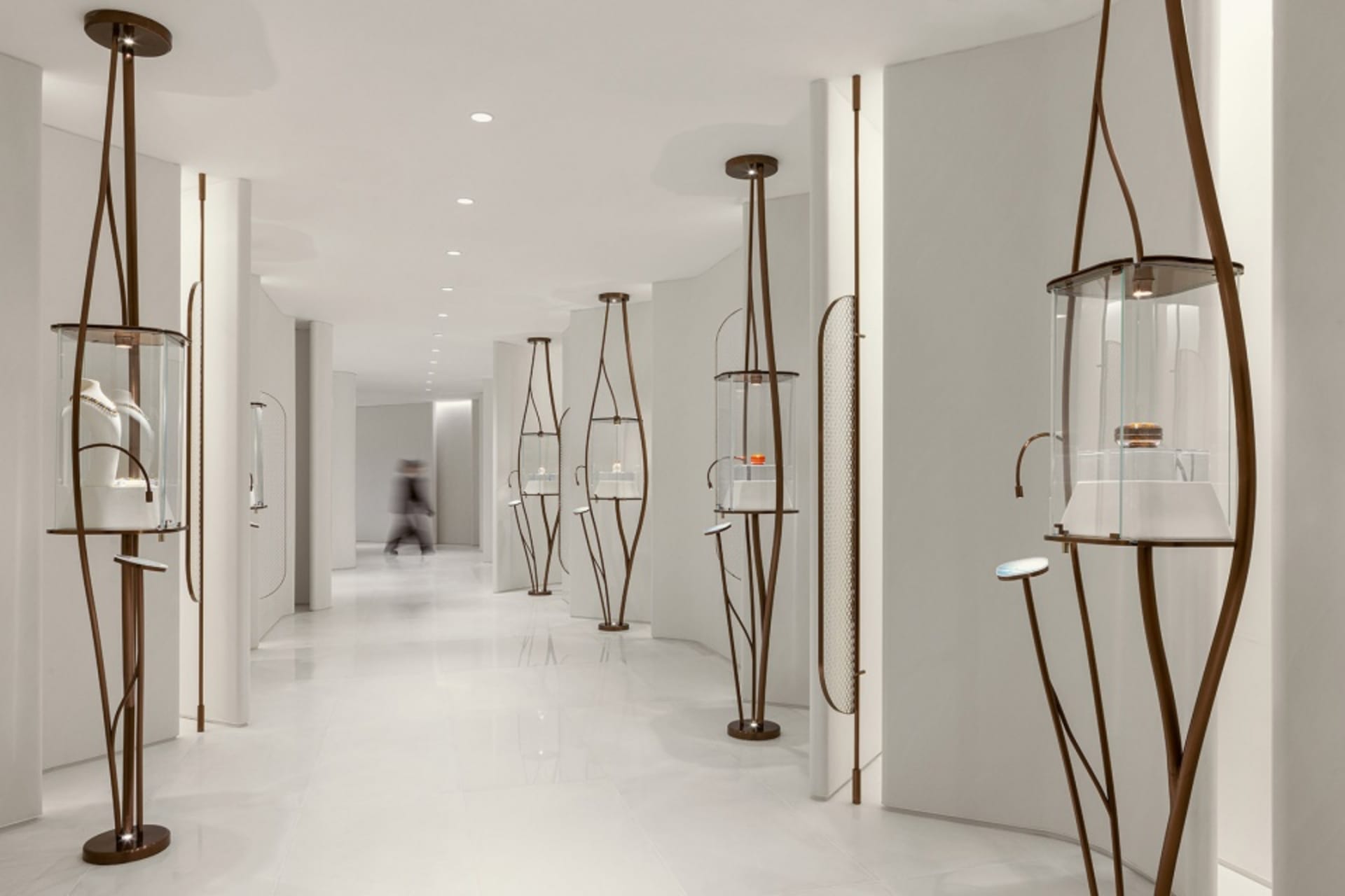A modern retail store with metal shelving units displaying glass products.