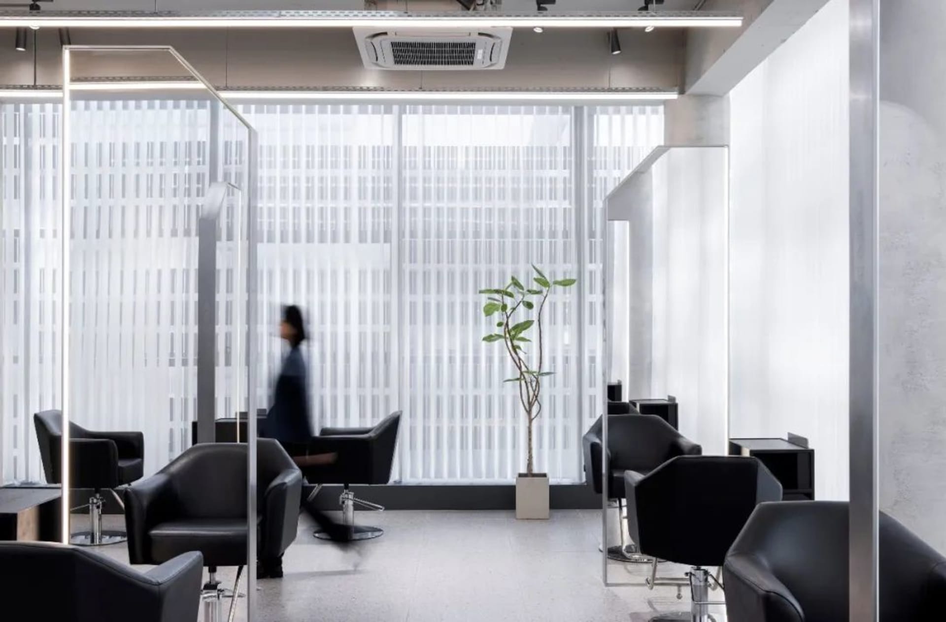 Modern interior space featuring glass, concrete, and metal