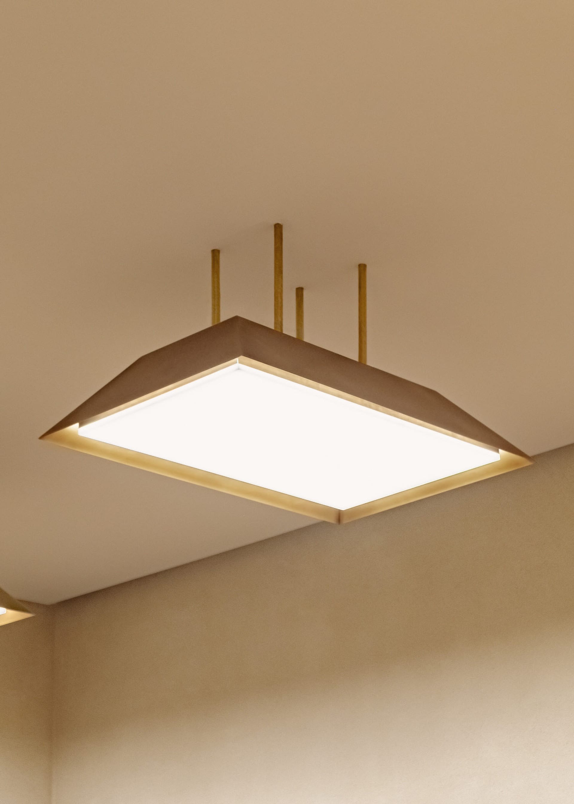 Modern, minimalist lighting fixture made of concrete material.