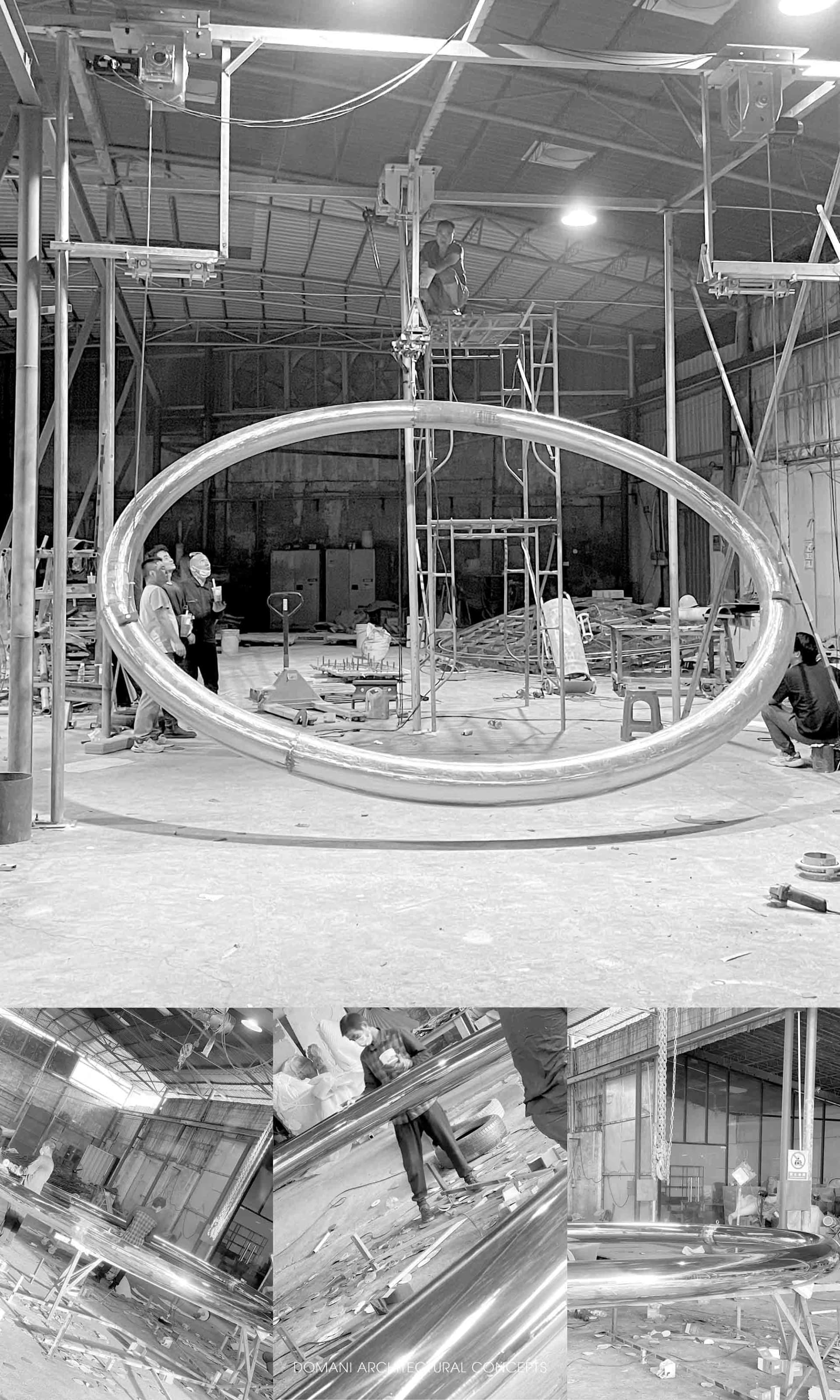 A construction site featuring shiny metal structures and workers in a warehouse environment.