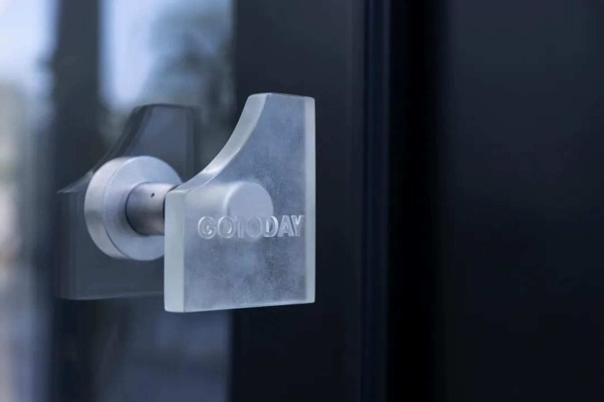 A glass door handle with the text 'GOTODAY'.