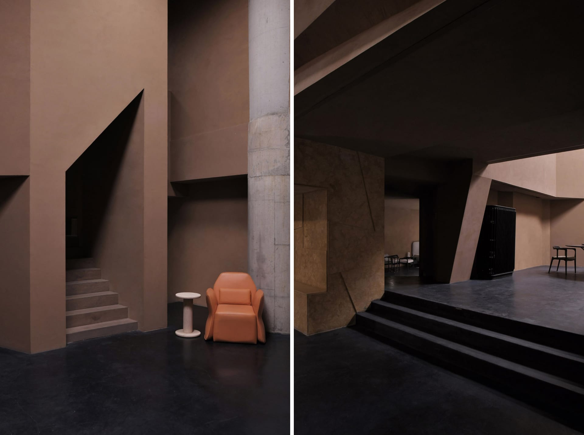 Lobby area with modern concrete walls, minimalist design, and a single orange armchair.