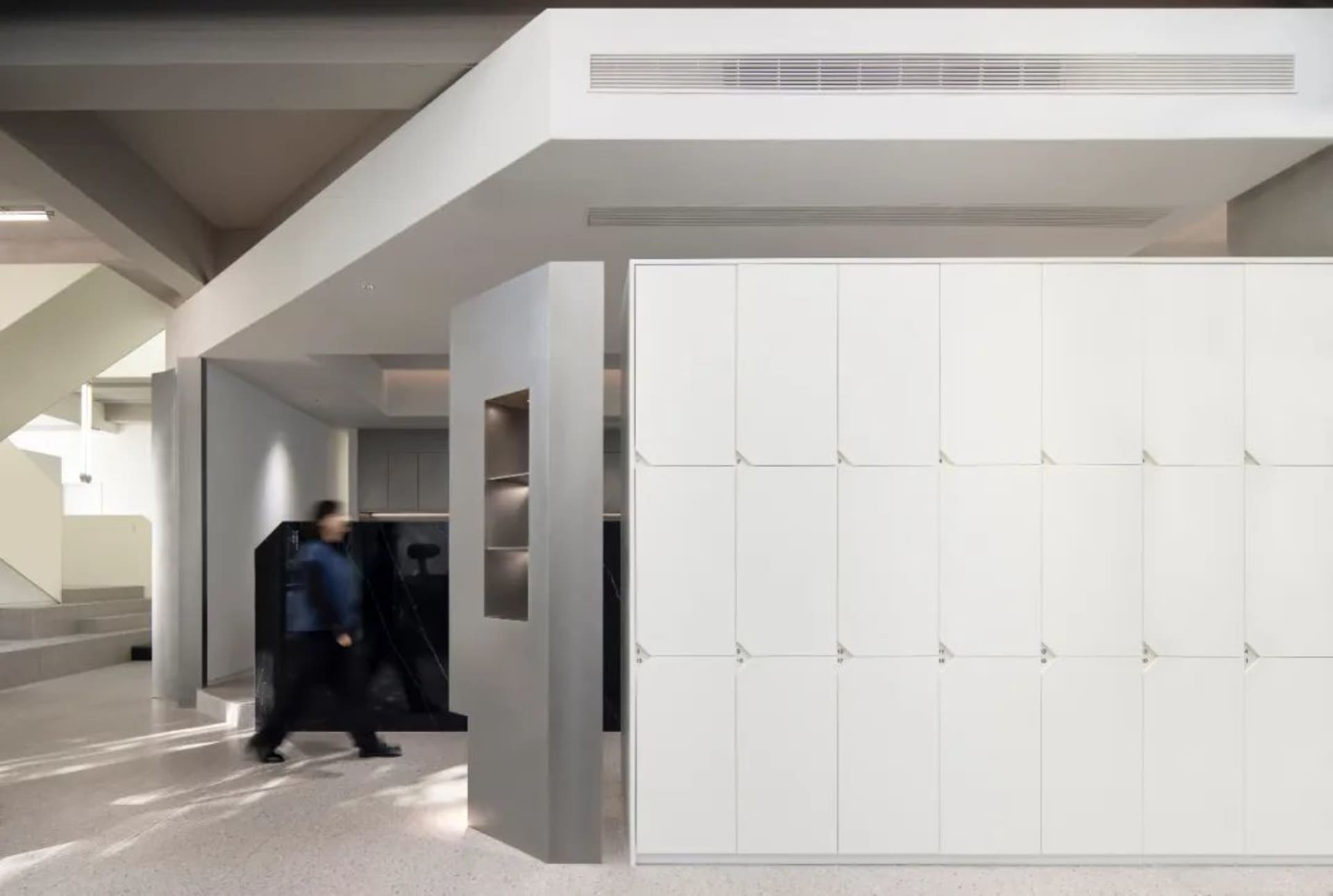 A modern office interior featuring concrete walls and a minimalist design.