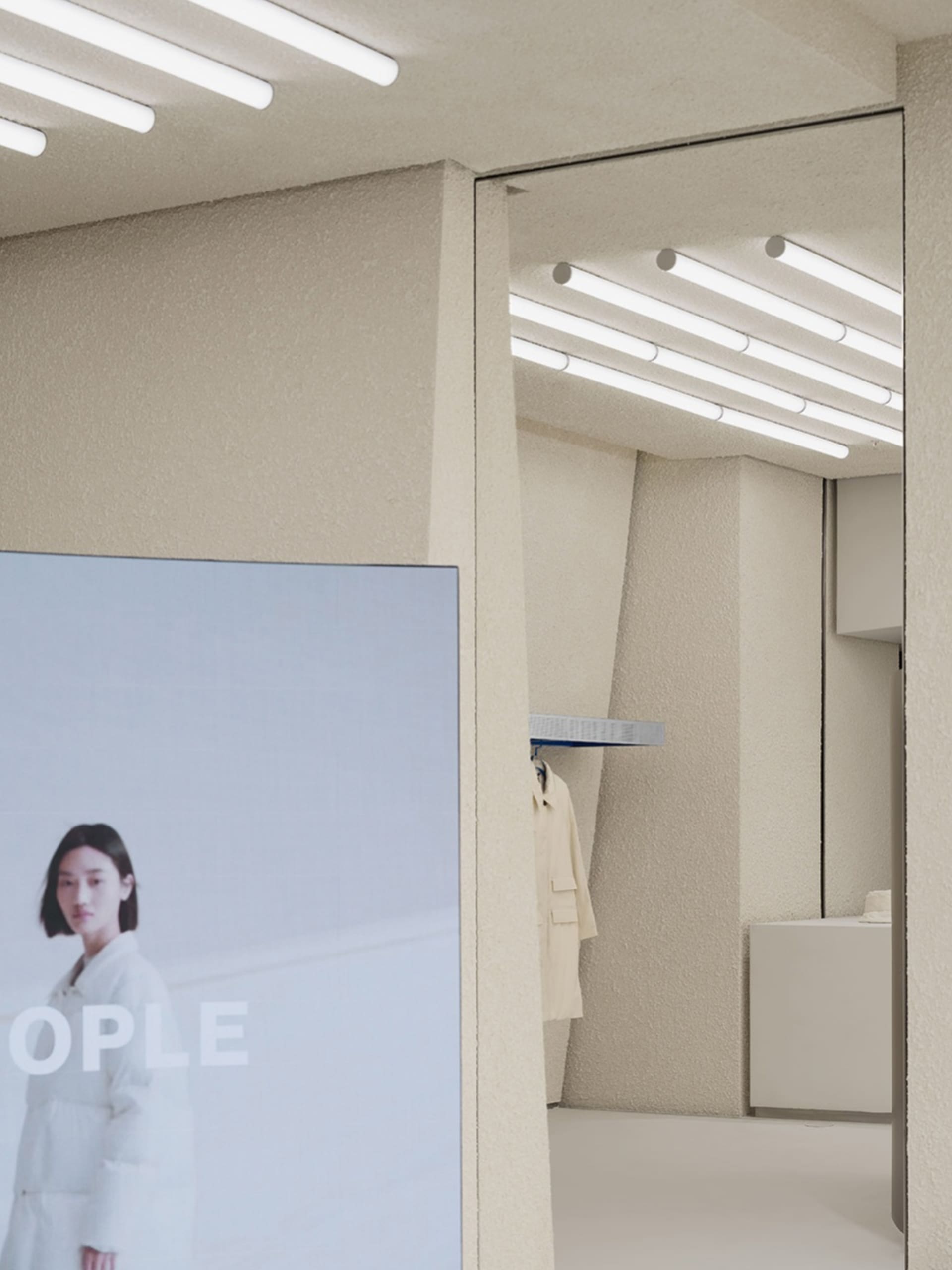 Modern retail space with a concrete floor, wooden walls, and a large image of a person in a white coat.