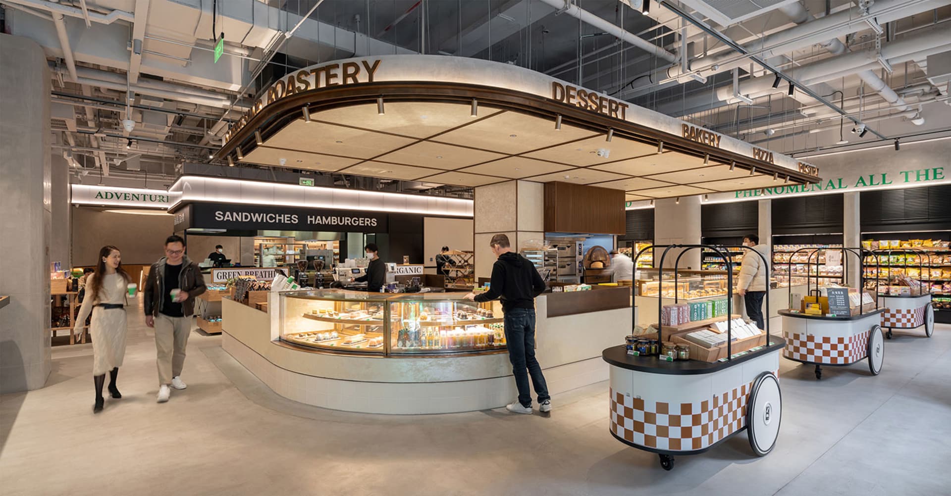 Modern food court with various food stalls and shopping carts.